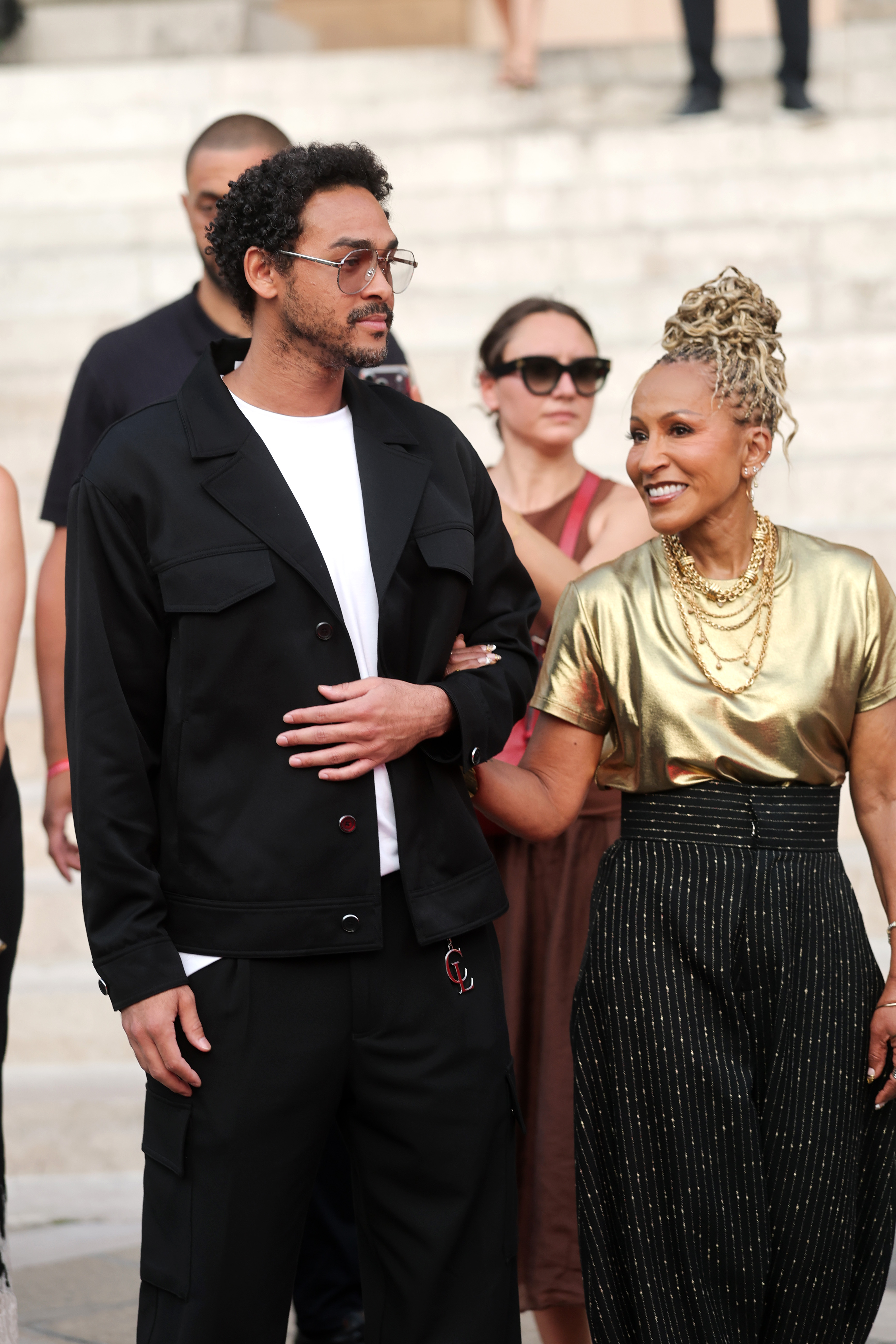 Trey Smith and Adrienne Banfield-Norris might not be related by blood, but it looked like they got along well. For this appearance, they attended the Christian Louboutin Men Spring/Summer 2027 Presentation as part of Paris Fashion Week at an unspecified venue on June 24, 2026, in Paris, France. | Source: Getty Images