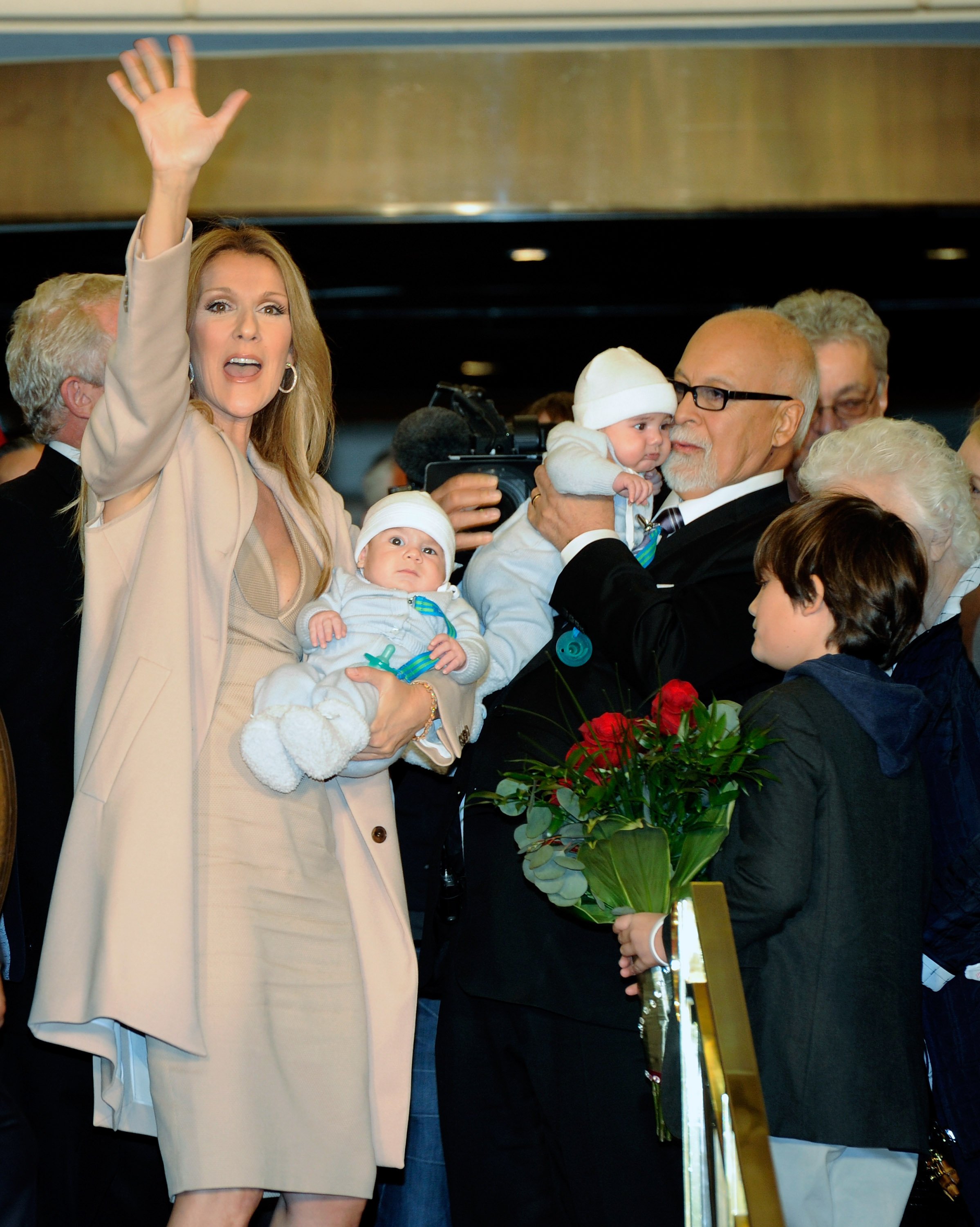 Celine Dion pictured waving while holding her son Nelson Angelil next to Rene Angelil, who holds their son Eddy Angelil, and their first child Rene-Charles Angelil while arriving at Caesars Palace on February 16, 2011 in Las Vegas, Nevada. / Source: Getty Images