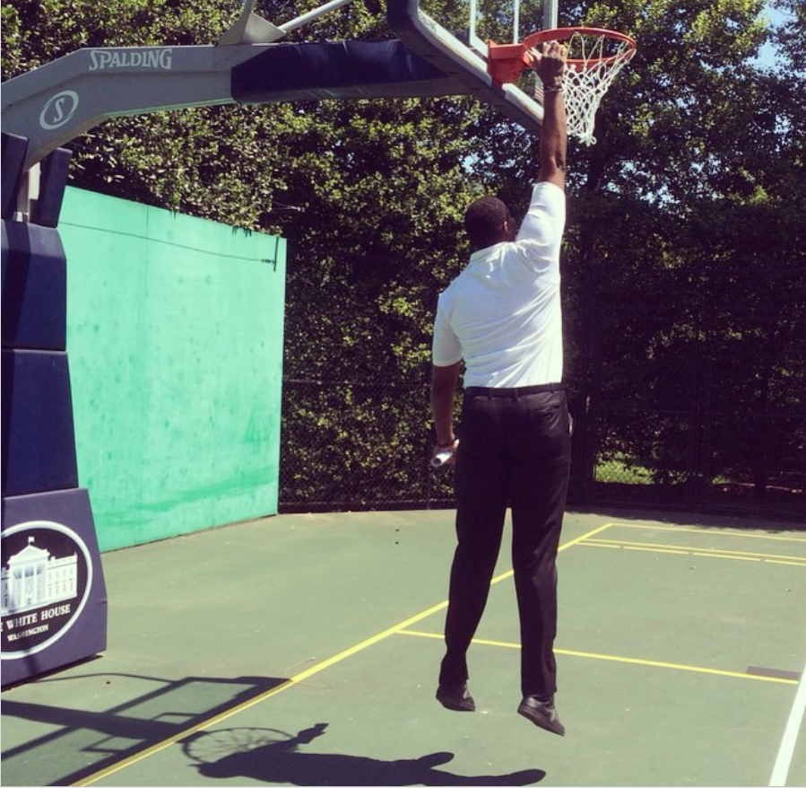 Jason Collins jumps toward the rim while playing around on the basketball court at the White House during a sunny outdoor visit. | Source: Instagram/jasoncollins_98