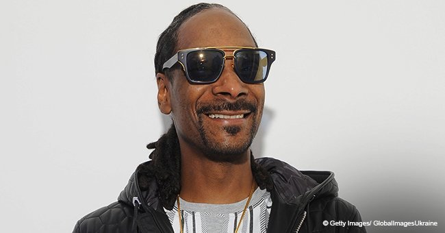 Snoop Dogg's wife cuddles their grandson with curly hair & brown eyes in new pic