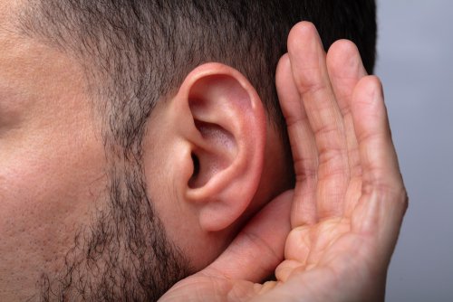A close up of a man trying to hear. | Source: Shutterstock.