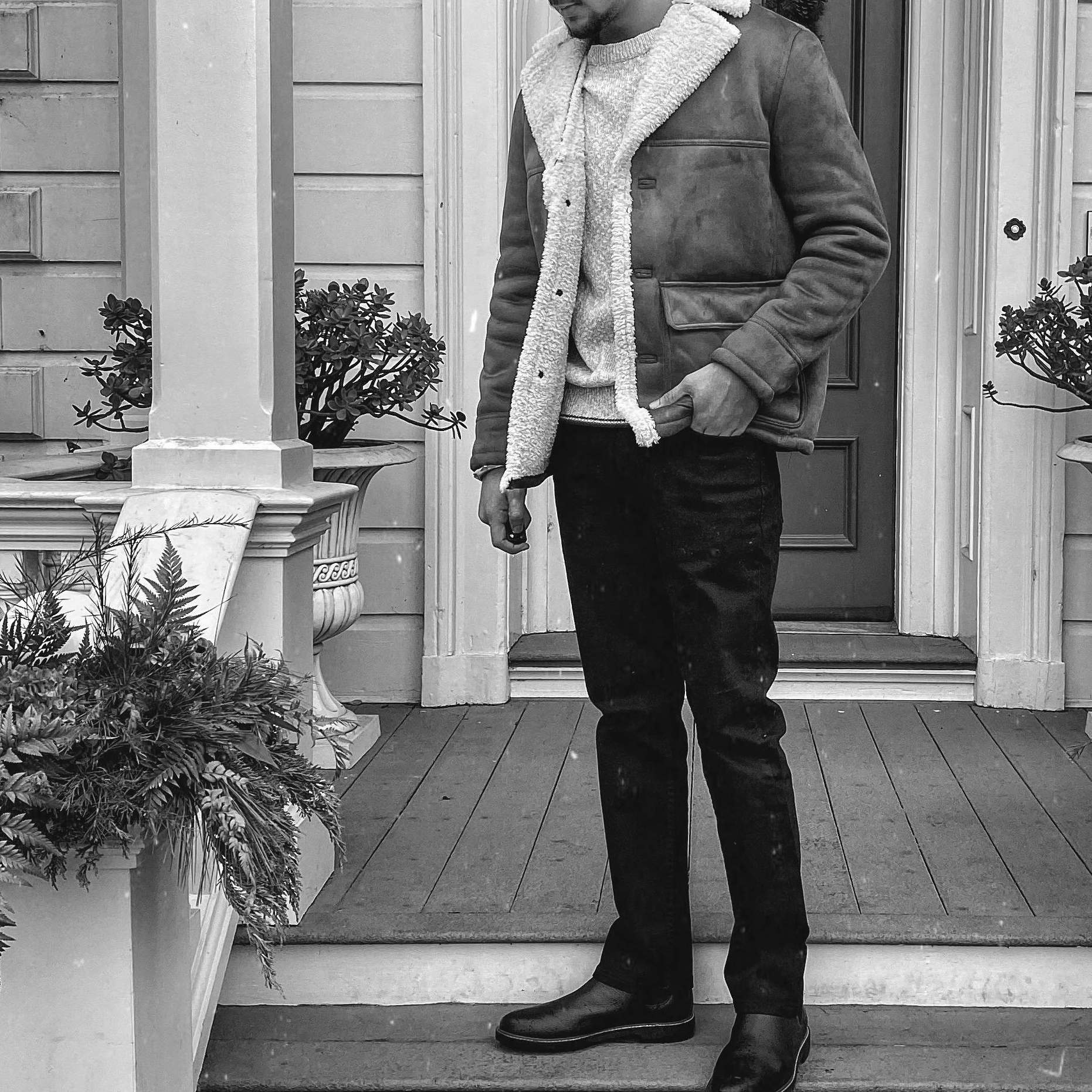 A man standing on a front porch, looking down thoughtfully | Source: Pexels