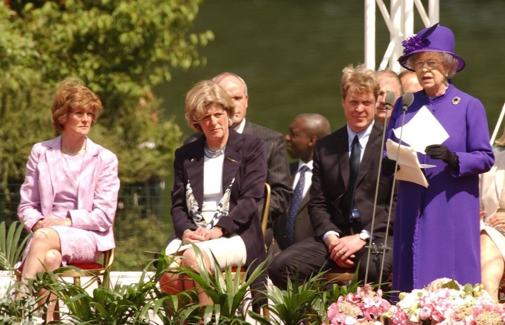 The sisters of the late Diana, listen to a speech by Britain's Queen Elizabeth II at the opening of a fountain built in memory of the princess in London's Hyde Park | Photo: Getty Images