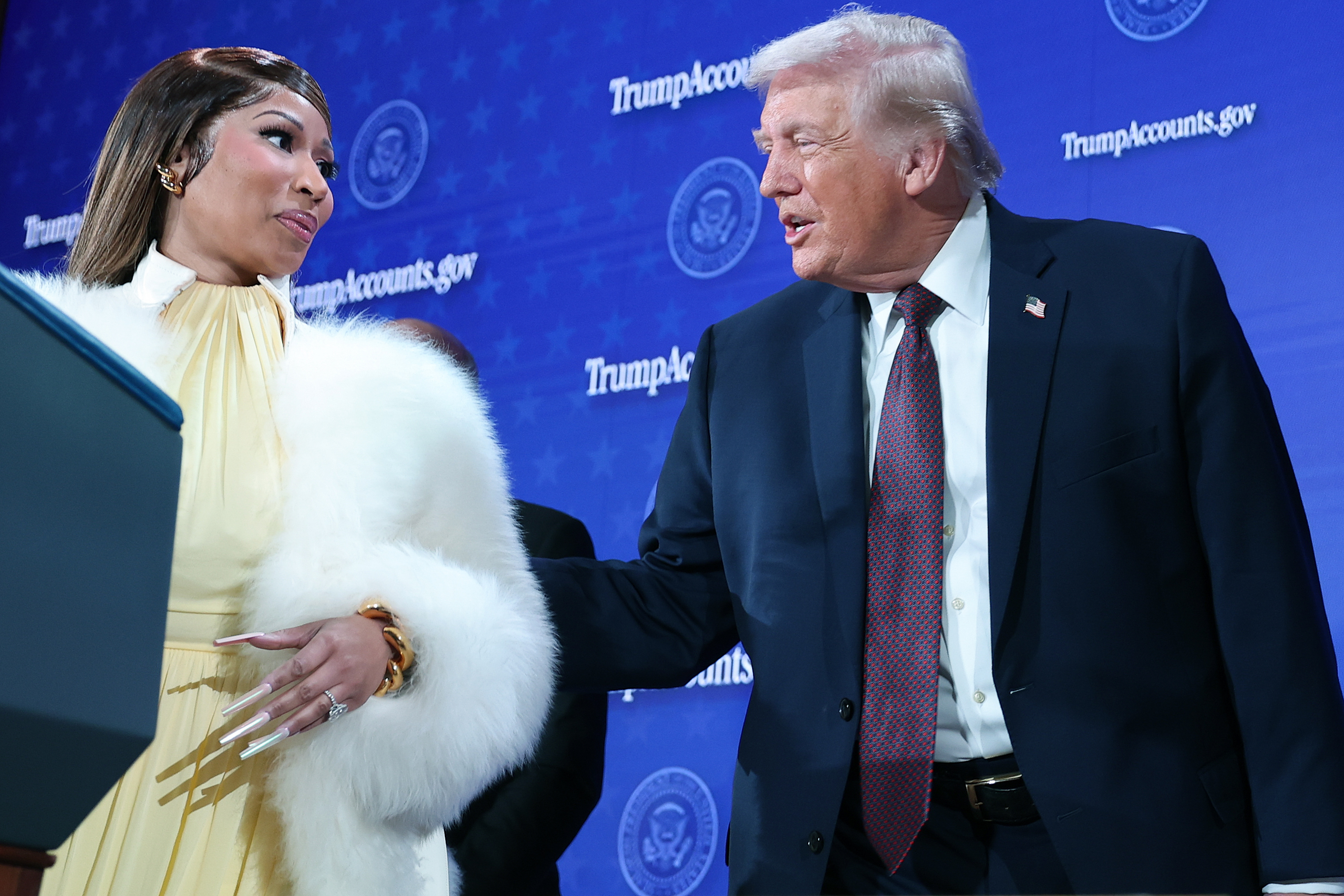 U.S. President Donald Trump reaching toward Nicki Minaj as he addresses her. | Source: Getty Images
