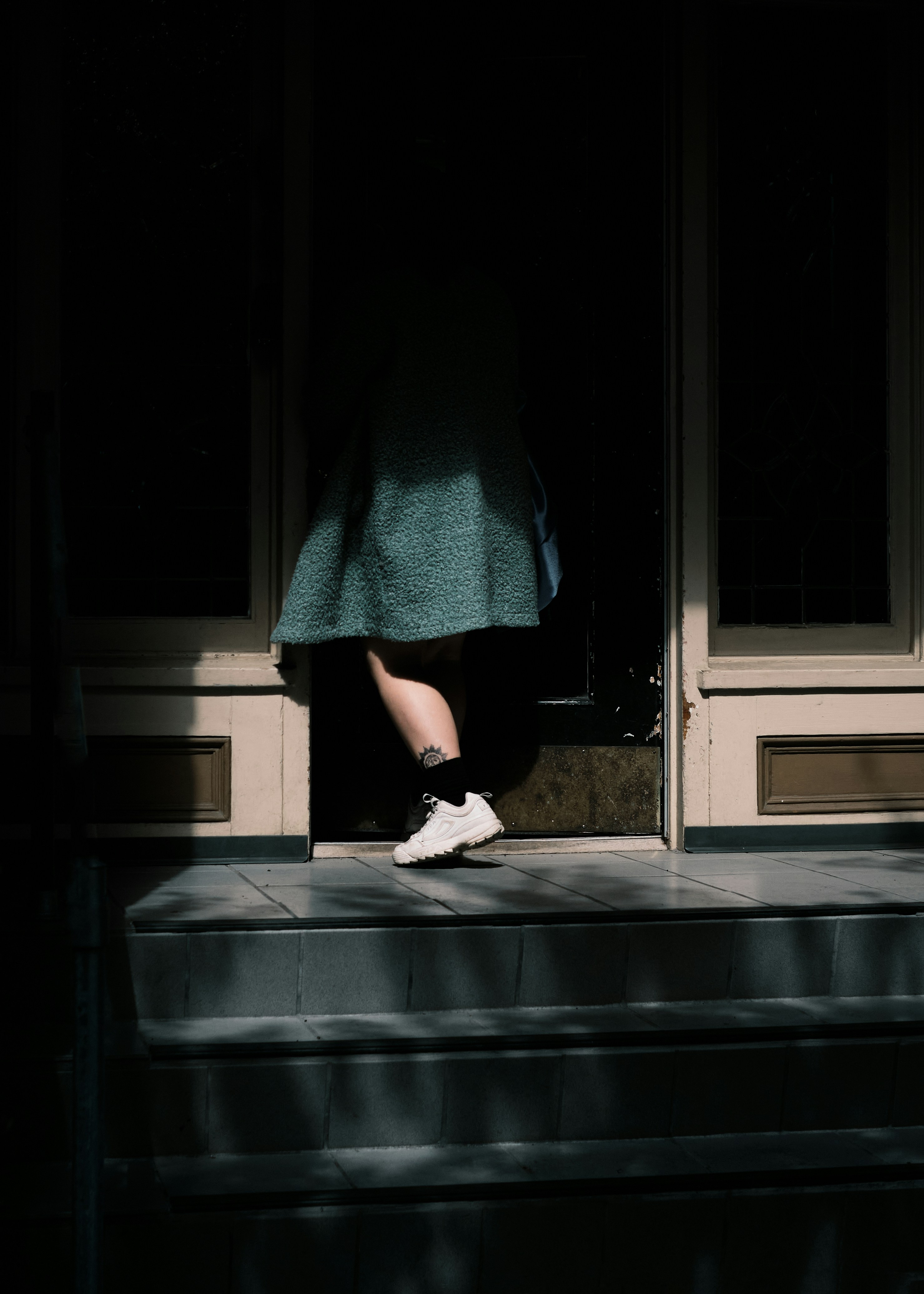 A female sneaking out of a house at night | Source: Unsplash