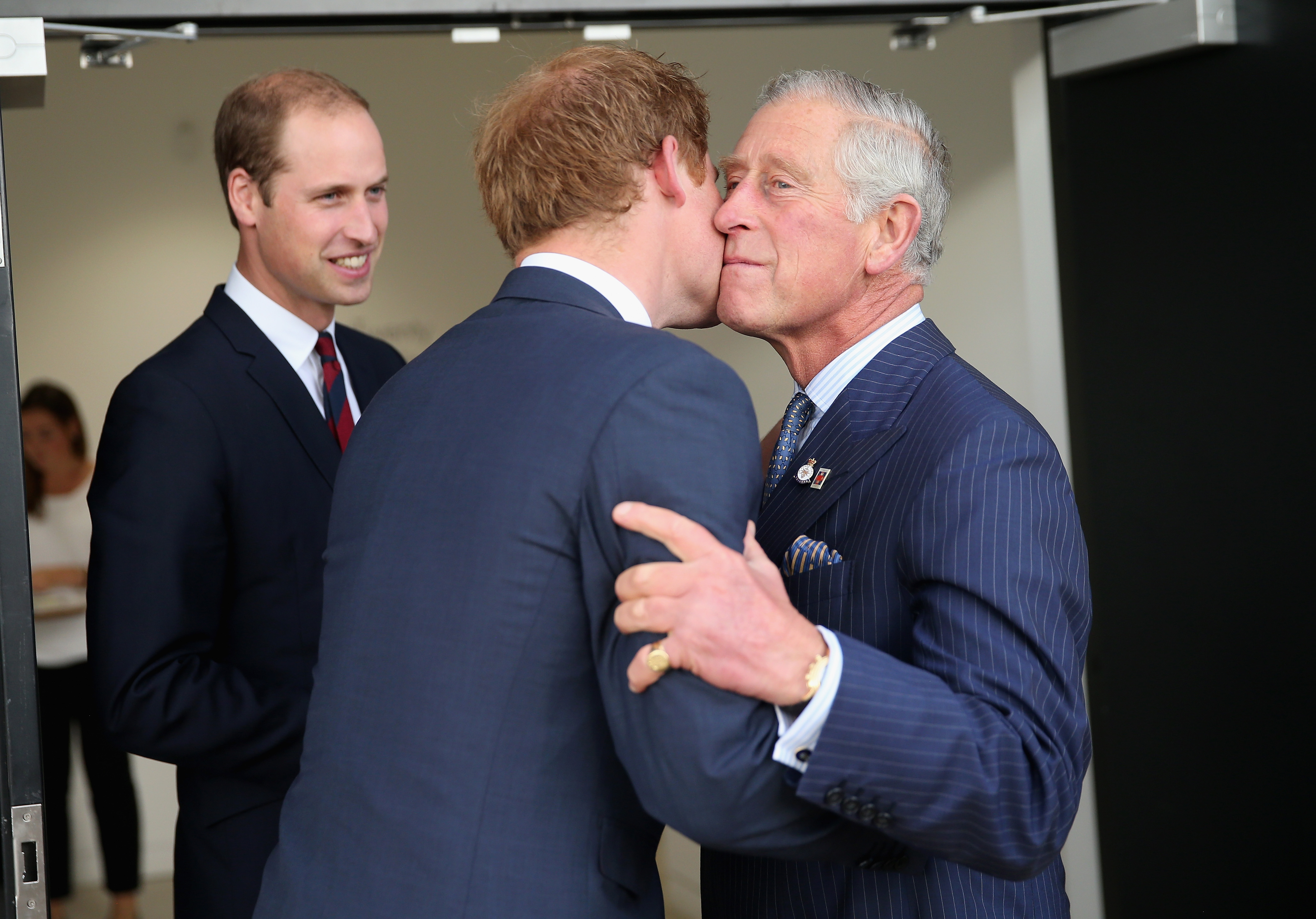 Prince William looks on as King Charles kisses Prince Harry at Queen Elizabeth II Park on September 10, 2014 in London, England. | Source: Getty Images