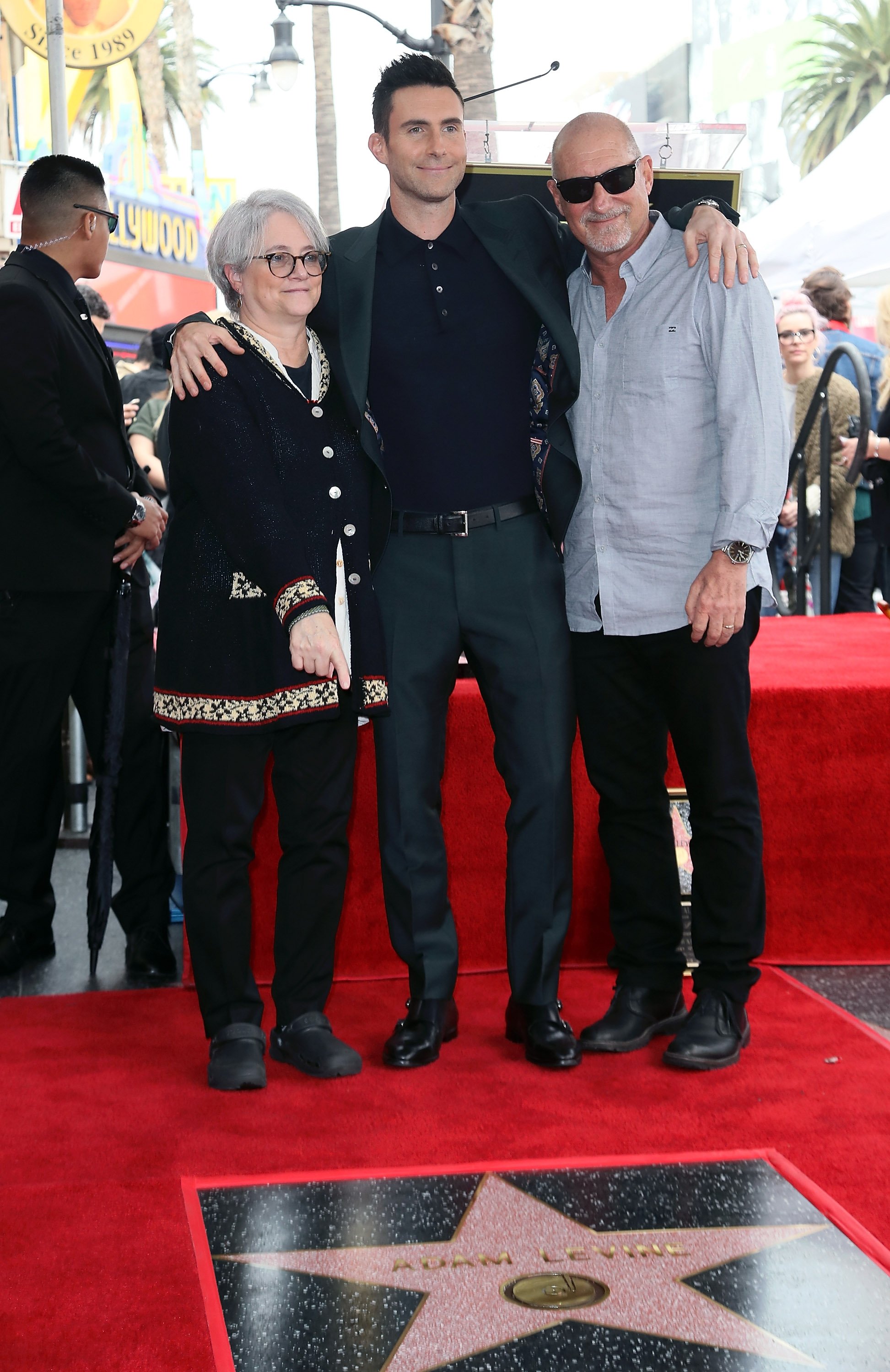 Adam Levine poses with parents, Patsy Noah and Fred Levine, as he was honored with a Star on the Hollywood Walk of Fame on February 10, 2017 | Source: Getty Images