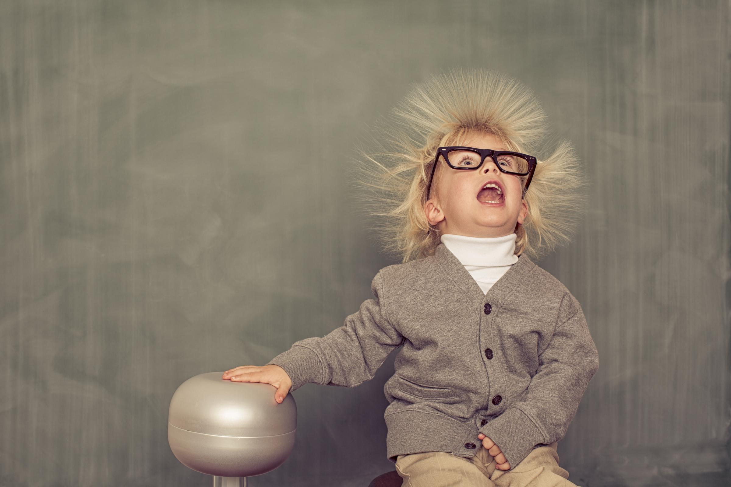 A young boy's hair stands on its ends due to static electricity | Source: Getty Images