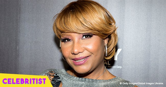 Traci Braxton rocks long red braids and tight jeans after becoming a grandma 