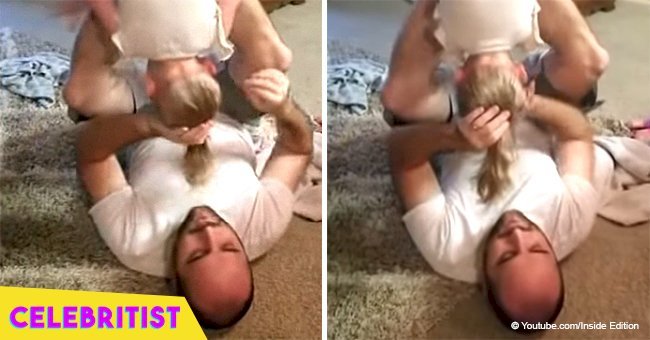 Dad shows how he does his 2-year-old daughter's hair upside down 