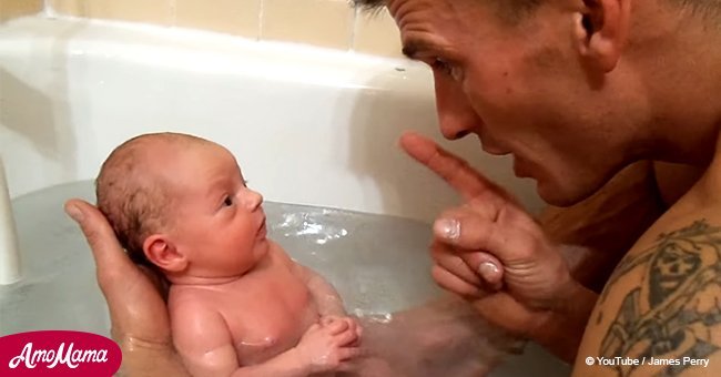 Dad puts newborn baby in a bath for the first time. It's the cutest thing ever 