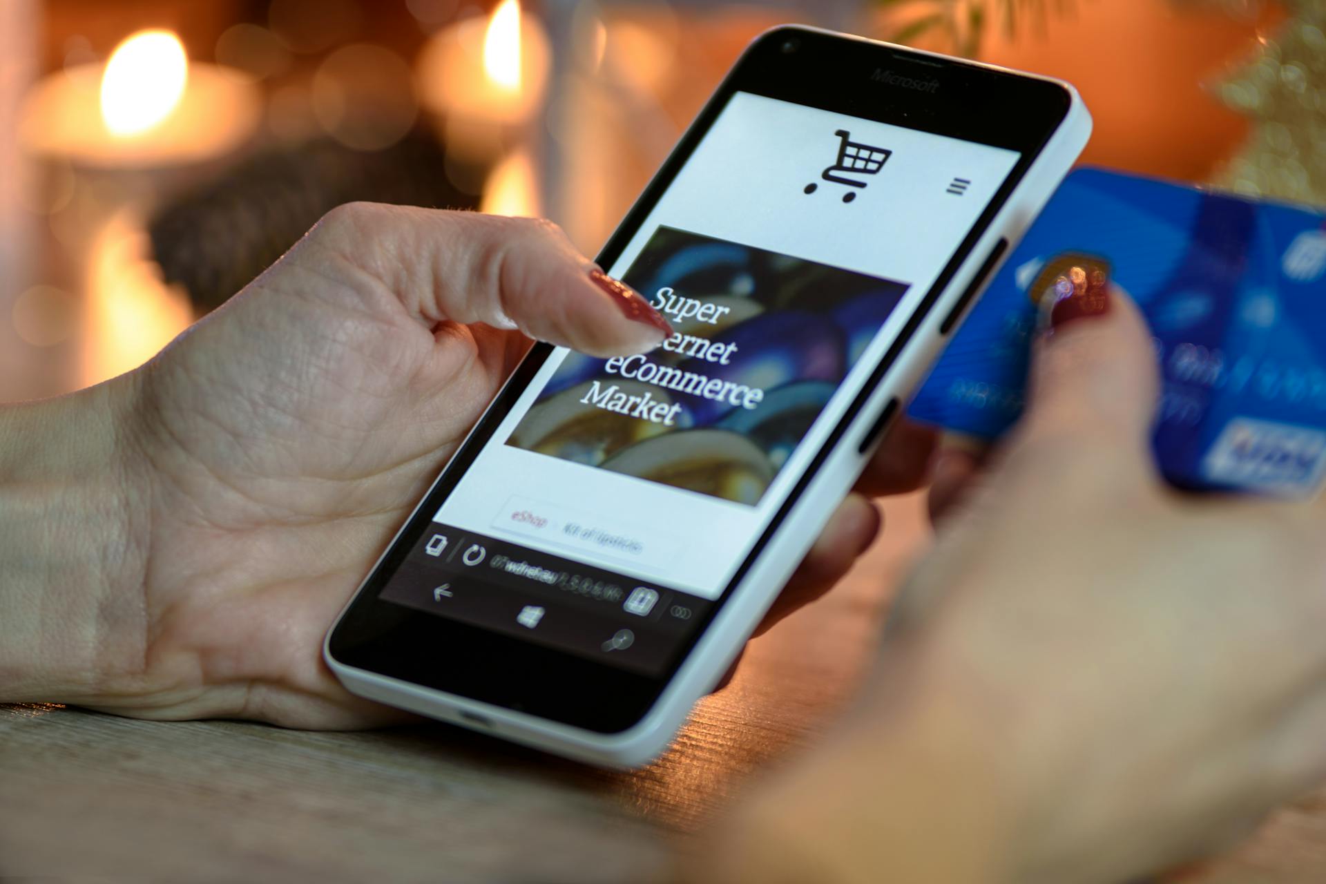 A woman holding a phone and a card | Source: Pexels