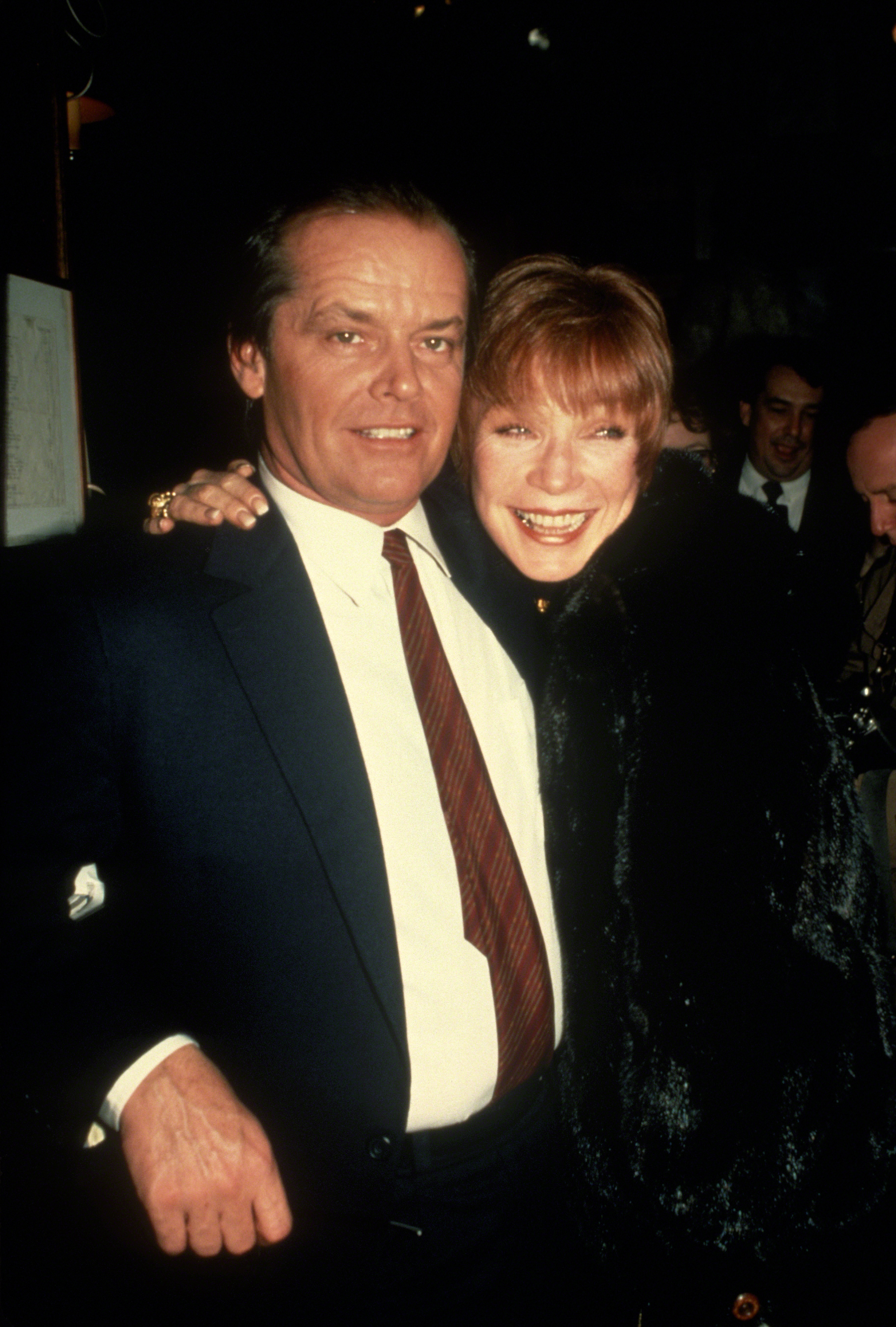Old friends, lasting legends — Jack Nicholson and MacLaine share a laugh in New York City, circa 1984. Linked arm in arm, the off-screen camaraderie between these two titans of cinema radiates through this relaxed, heartfelt moment.