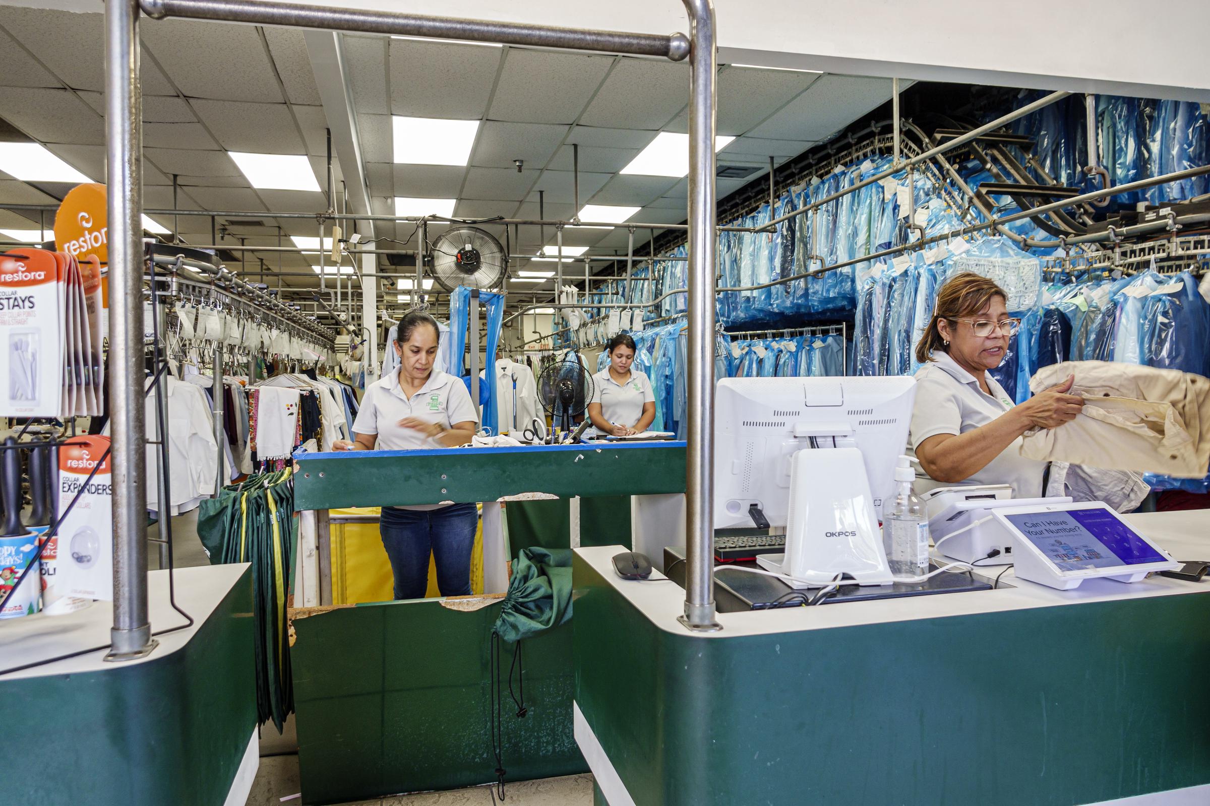 Women working at a dry cleaning facility | Source: Getty Images