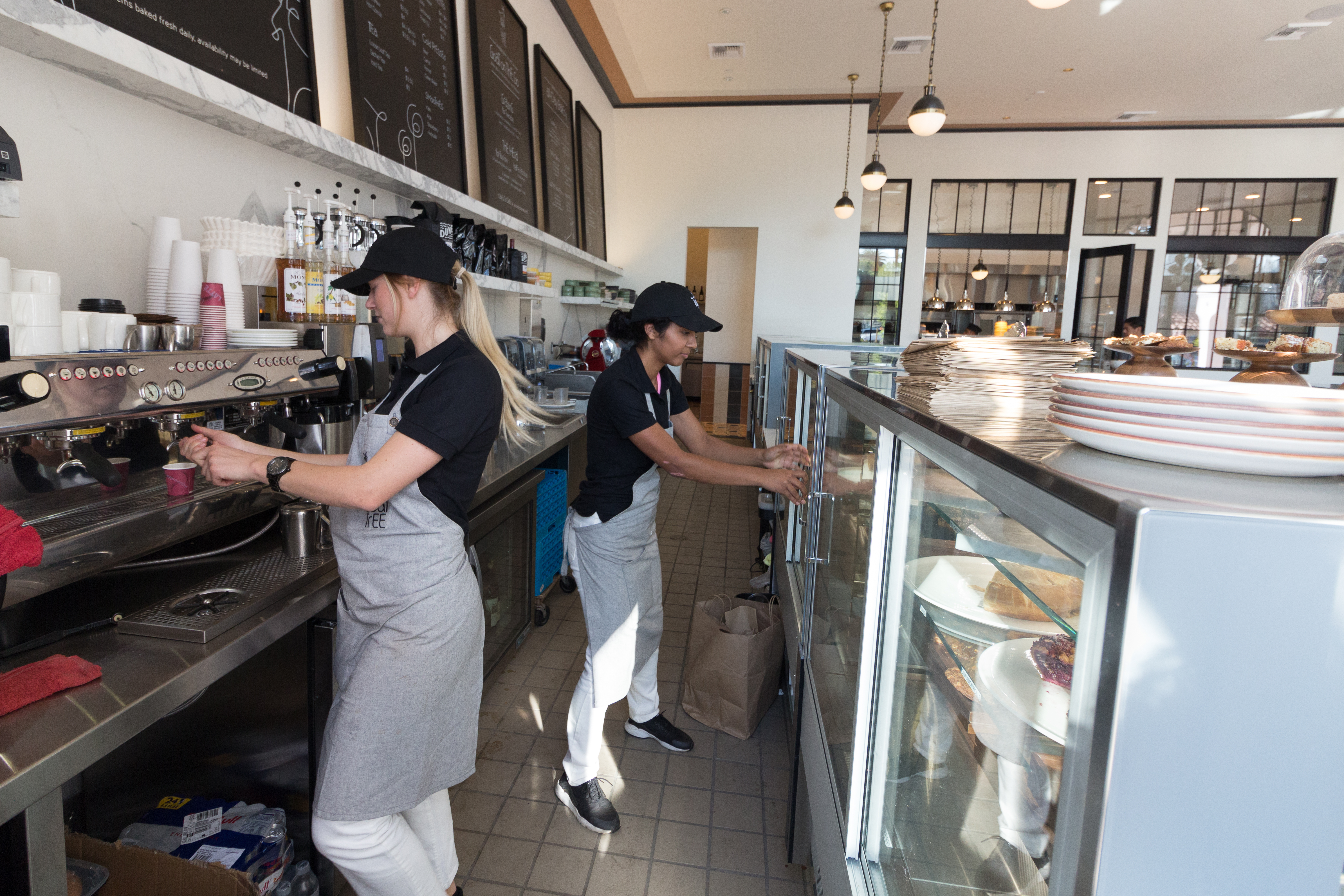 Two women working at a coffee shop | Source: Shutterstock