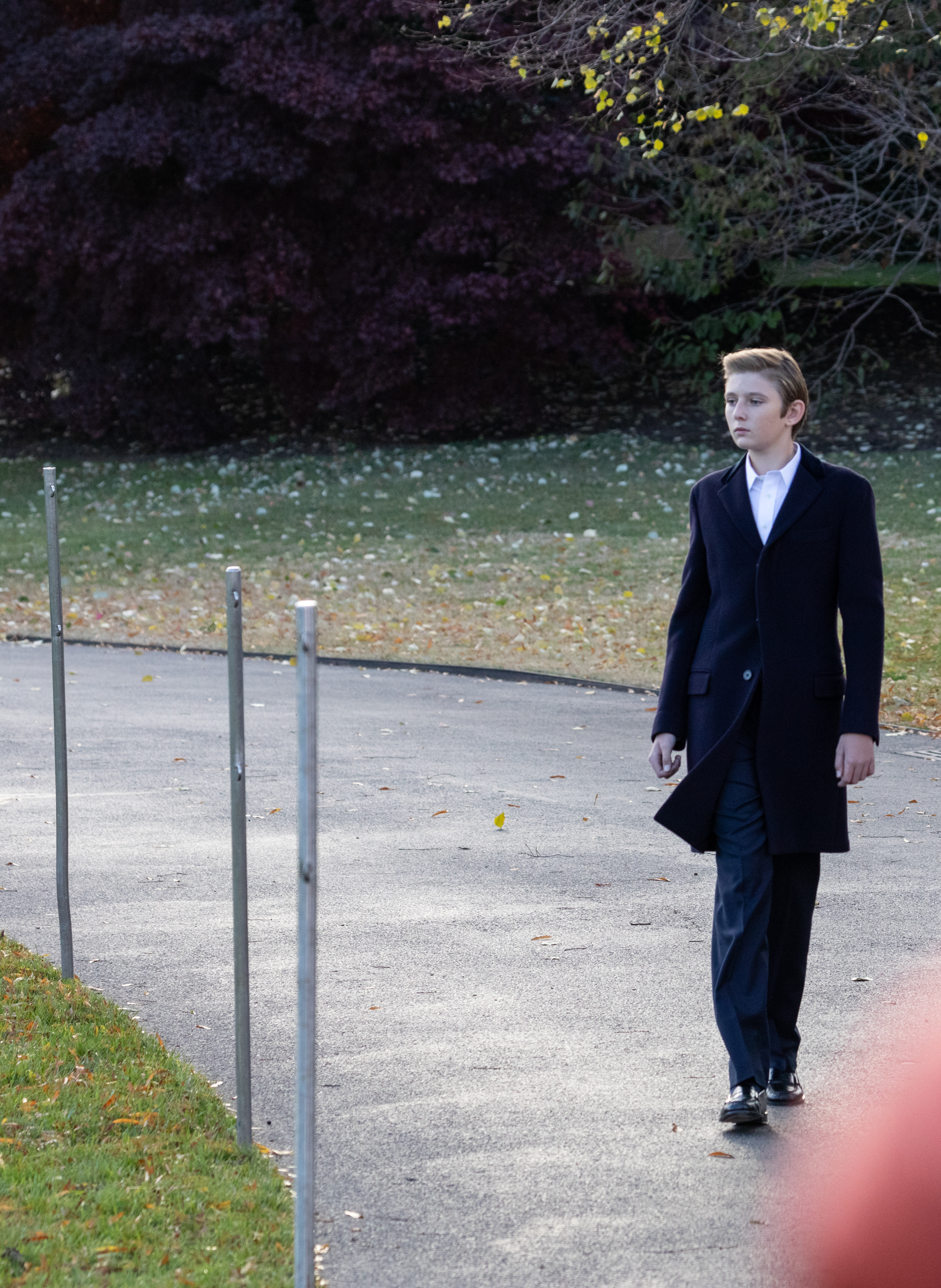 Barron Trump walks across the South Lawn before his family departs from the White House in Washington, DC., on November 20, 2018. | Source: Getty Images