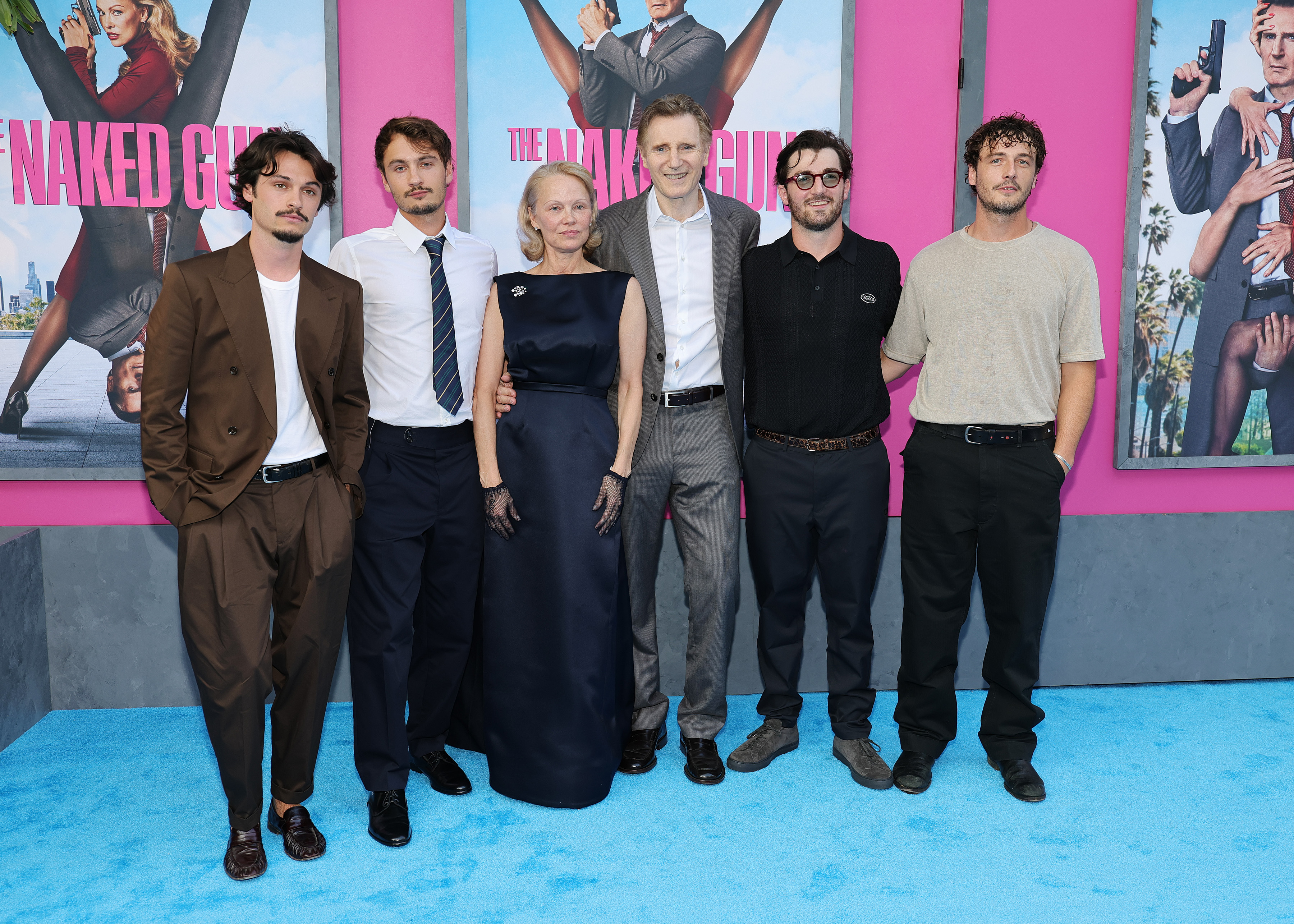 (L-R) Dylan, Brandon Lee, Pamela Anderson, Liam, Daniel Neeson, and Micheál Richardson pose at the New York premiere of "The Naked Gun," 2025 | Source: Getty Images