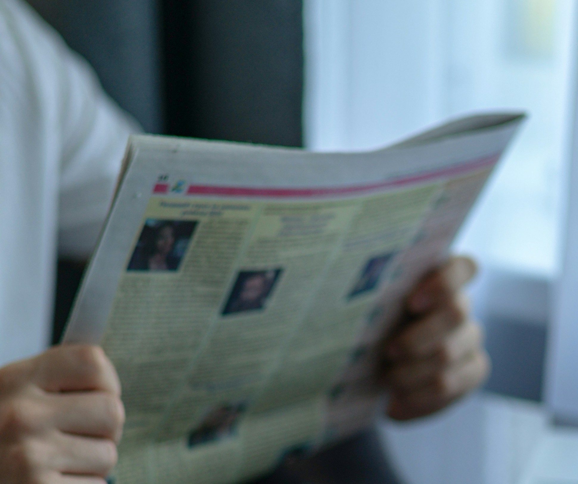 A teenage boy holding a newspaper | Source: Unsplash