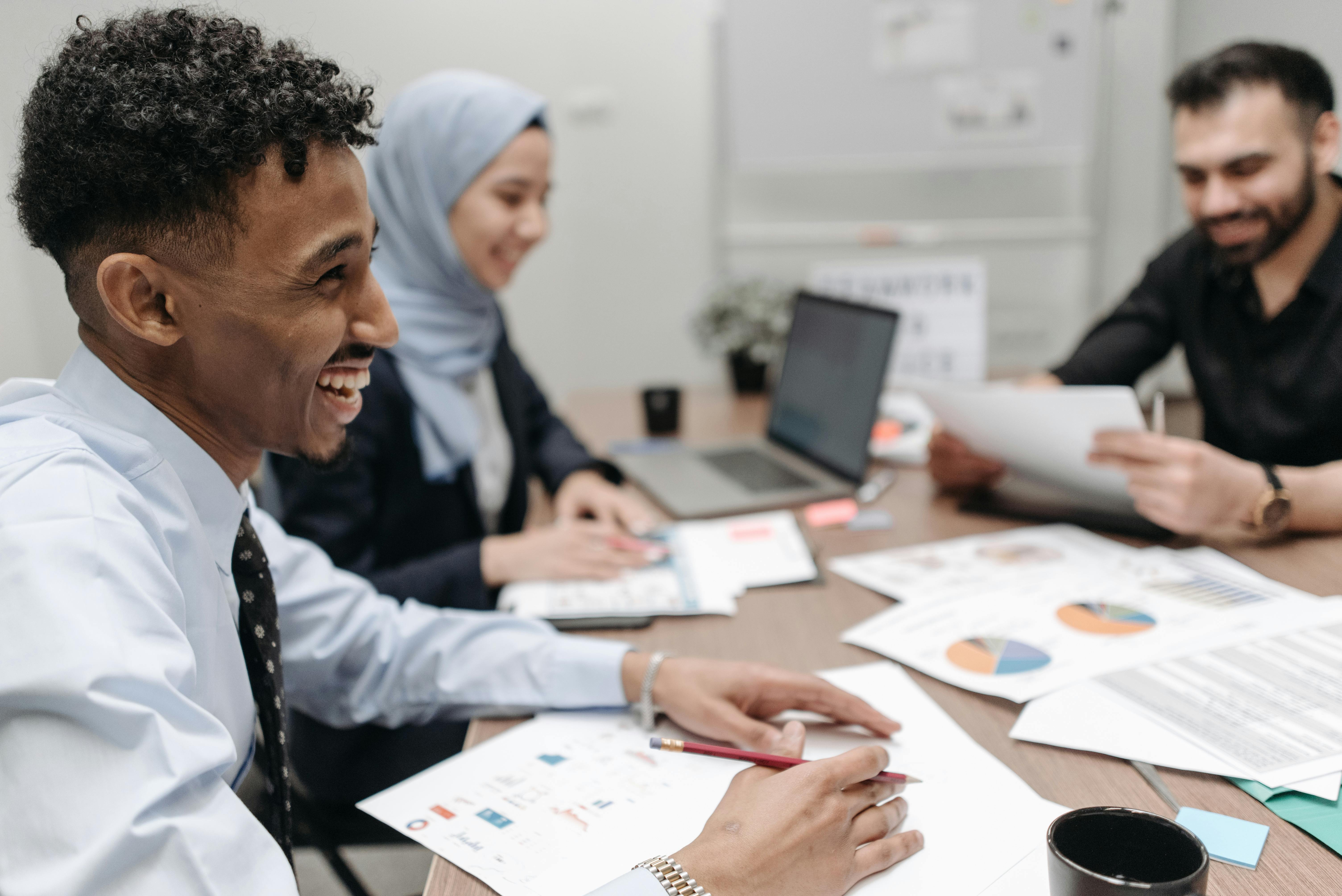 Happy people at a workplace | Source: Pexels