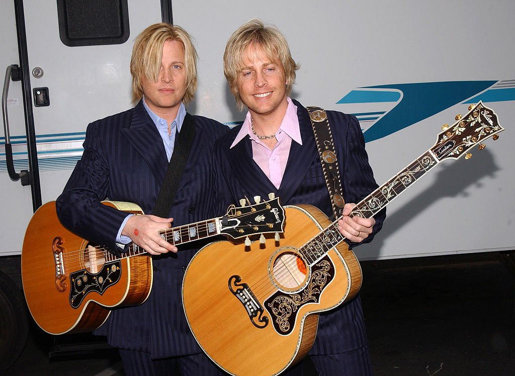 Gunnar and Matthew Nelson smiling and holding guitars. | Source: Getty Images