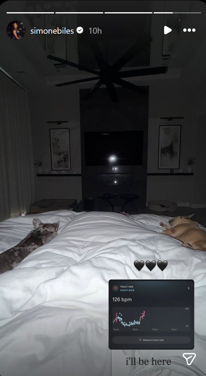 Hours before revealing details of a frightening health scare, Simone Biles posted a photo from bed showing her dogs and an elevated heart-rate reading. | Source: Instagram/simonebiles