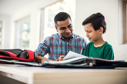 Photo of father and son doing homework at home | Photo: Getty Images