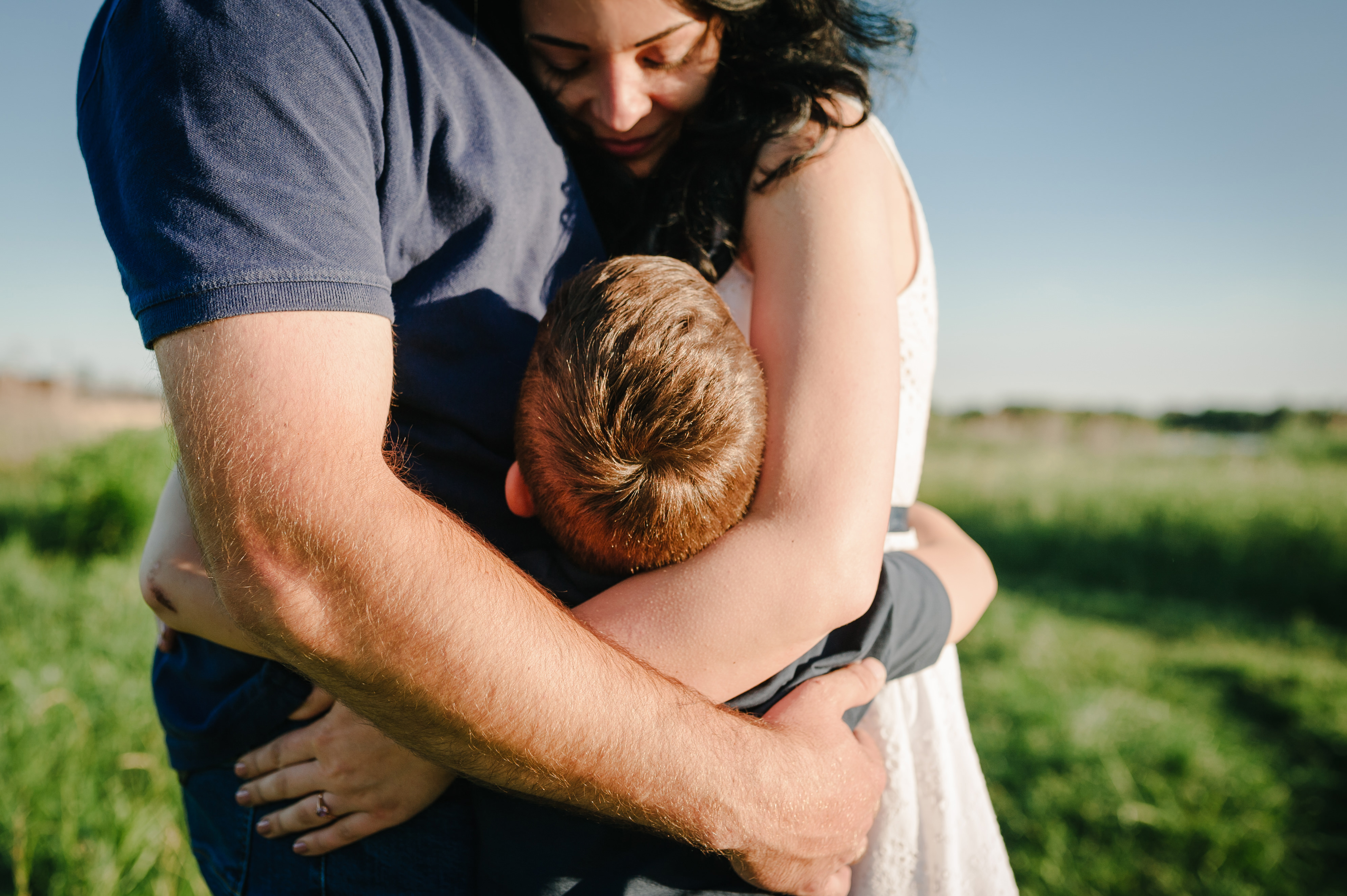 Boy hugs his parents | Source: Shutterstock.com