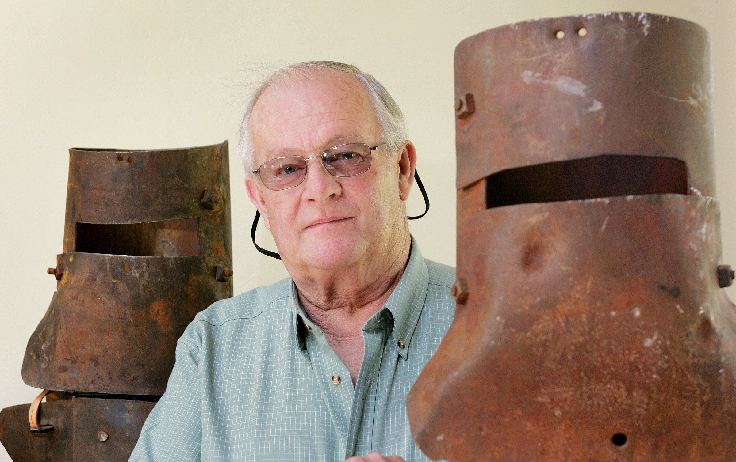 Mike Hastings pictured between the helmets of famous Australian outlaw Ned Kelly on 02 October 2005 in Jerilderie, Australia. / Source: Getty Images