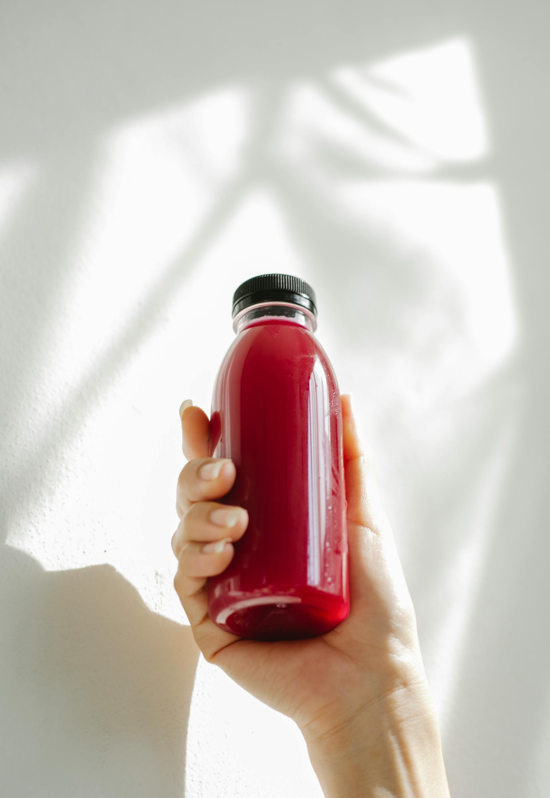 A person holding a bottle of juice | Source: Pexels