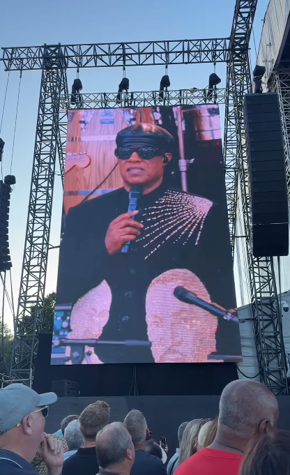 Stevie Wonder seen on a concert screen talking about the rumors about his eyesight during his tour stop at Cardiff, Wales on July 10, 2025 | Source: Instagram/cardifflife.wales