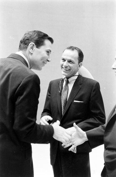 Frank Sinatra  laughs with television announcer Gene Rayburn backstage during the filming of an episode of the television variety program 'The Steve Allen Show,' New York, New York, August 19, 1956 | Photo: Getty Images