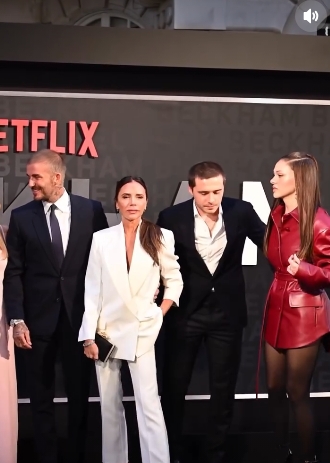 Brooklyn Peltz Beckham pulled Nicola Peltz Beckham into a family photo with Victoria and David Beckham during the 2023 premiere of Netflix's "Beckham," in a clip from a post dated January 20, 2026. | Source: Instagram/extratv