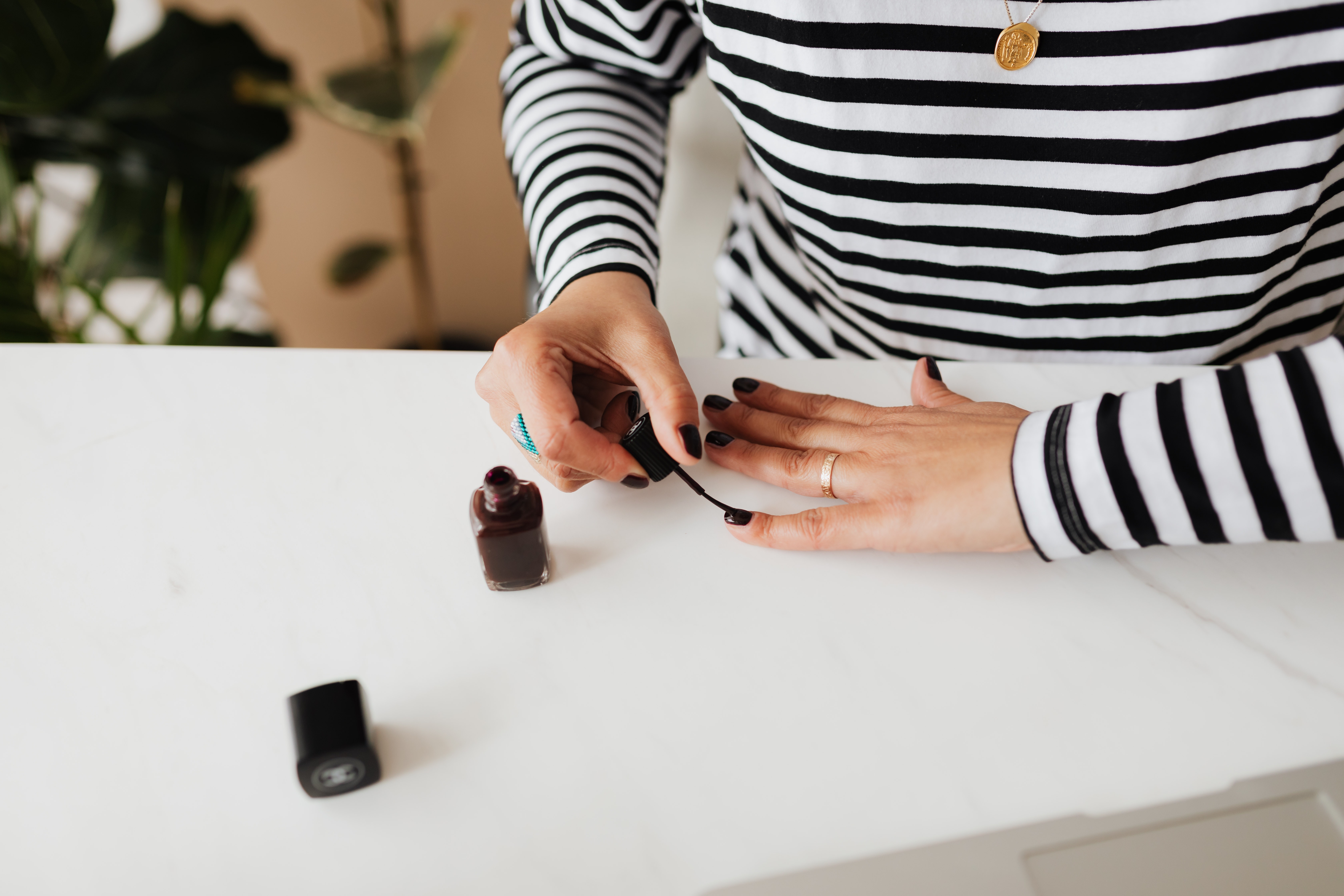 A photo of a woman applying nail polish | Source: Pexels