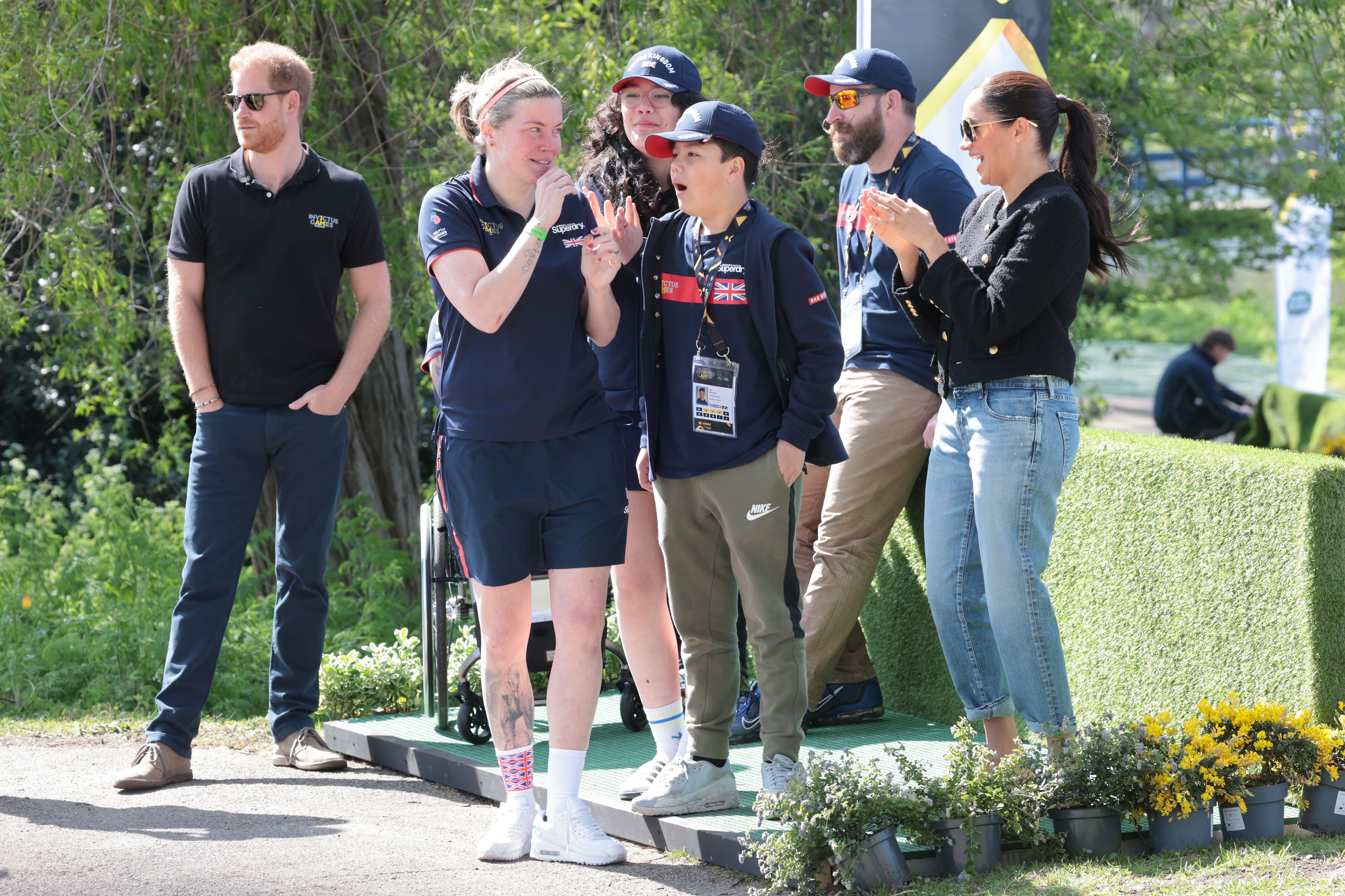  Prince Harry, Duke of Sussex and Meghan, Duchess of Sussex talk to members of Team United Kingdom during the Jaguar Land Rover Driving Challenge on day one of the Invictus Games The Hague 2020 at Zuiderpark on April 16, 2022 in The Hague, Netherlands. | Source: Getty Images