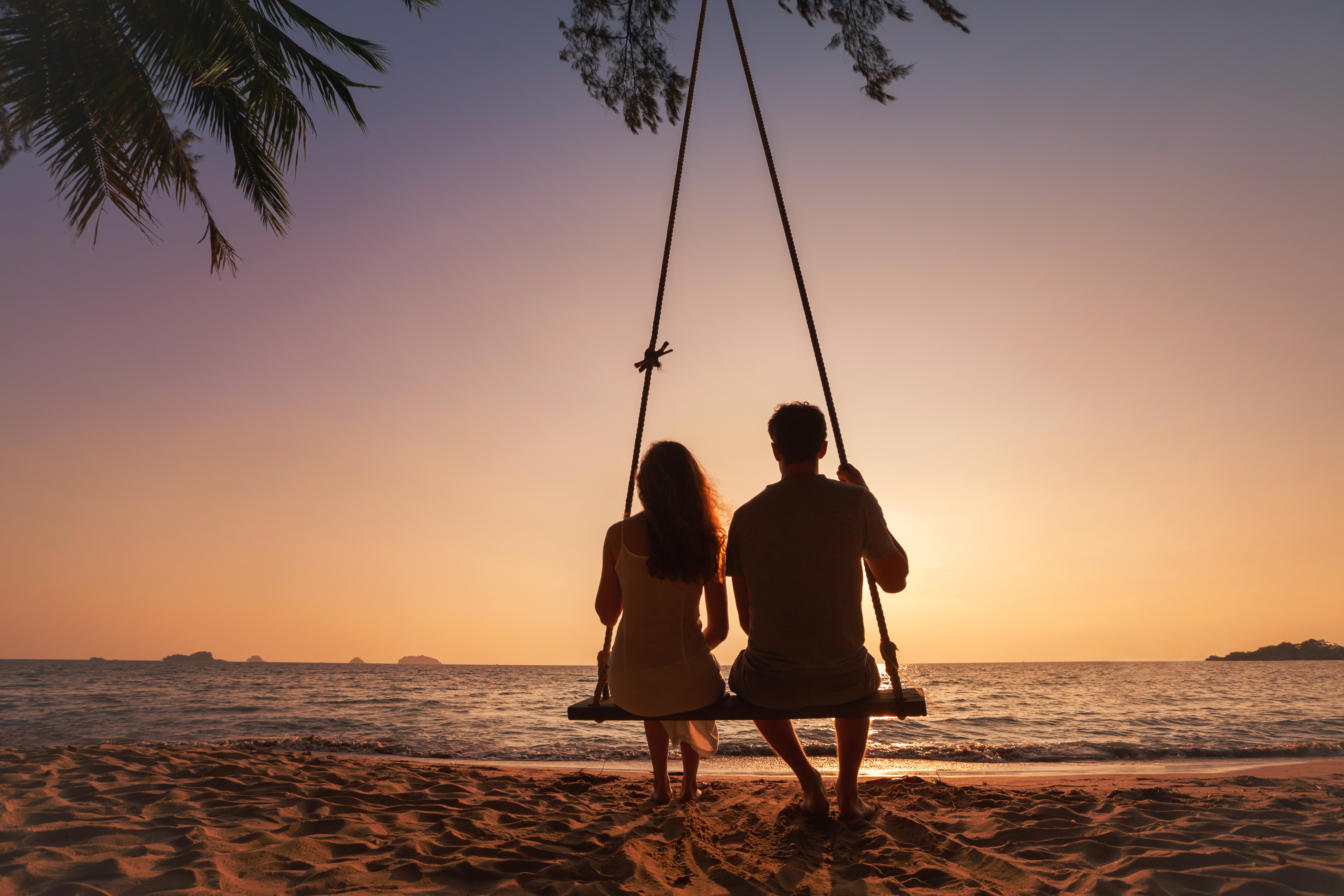 A couple enjoying sunset at the beach | Source: Shutterstock