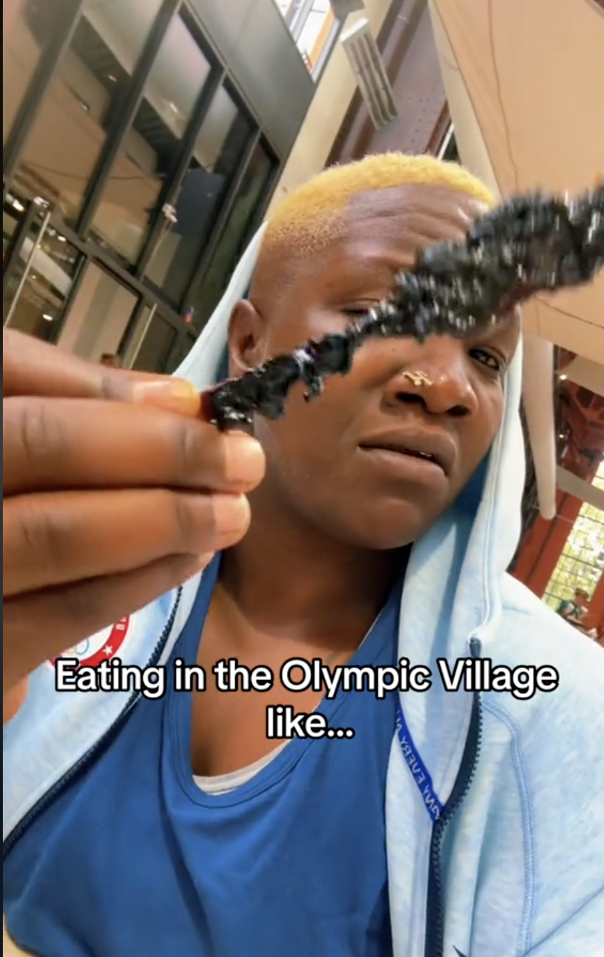 A screenshot of Raven Saunders holding some kind of skewer at the Olympic Village dining hall | Source: TikTok/giveme1shot