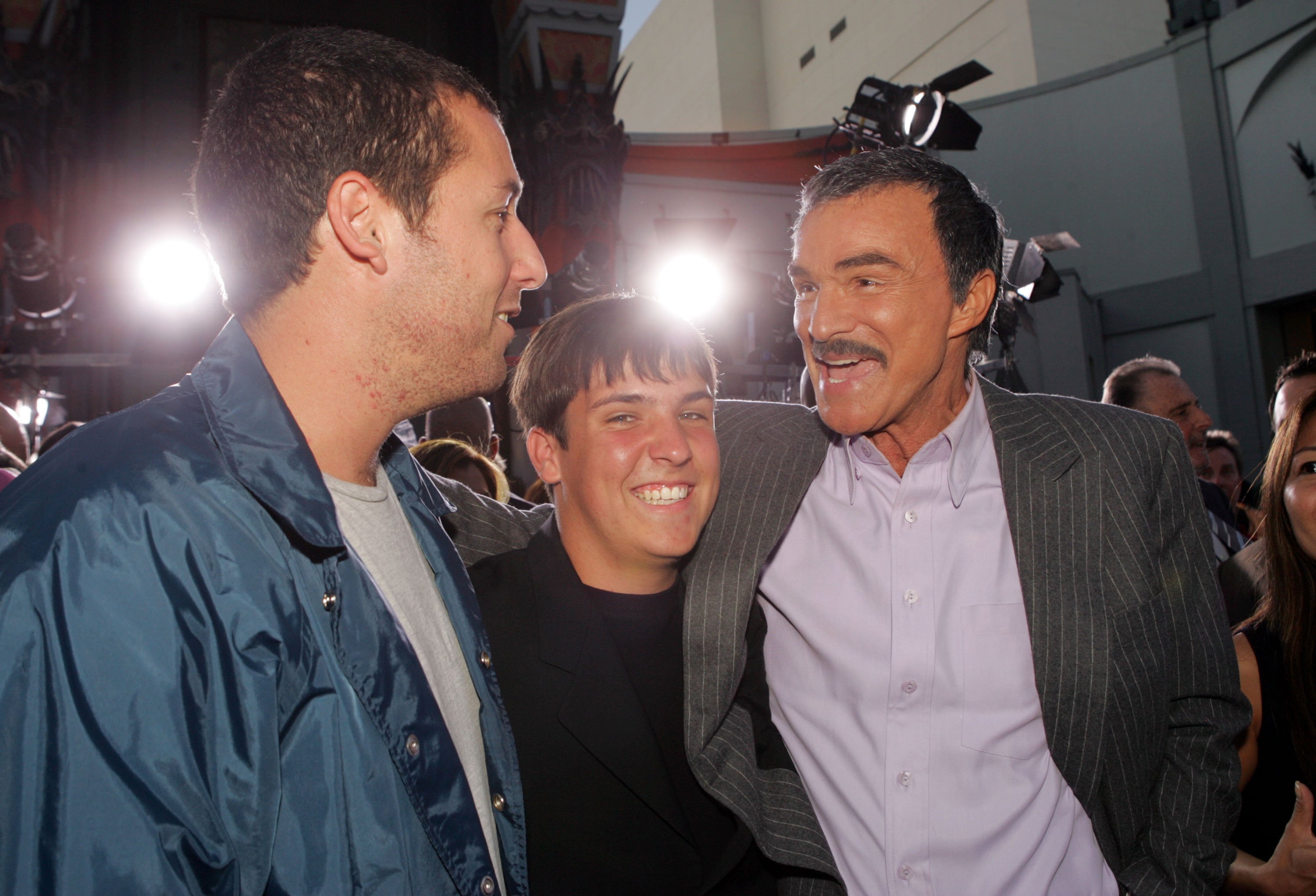 Adam Sandler and Burt Reynolds pose with Burts son Quinton at the premiere of Paramount Pictures' "The Longest Yard" at the Chinese Theater on May 19, 2005 in Los Angeles, California | Photo: Getty Images