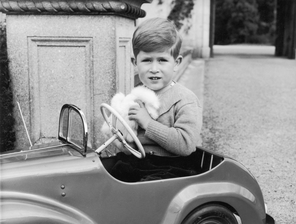 Prince Charles plays in a miniature car on the grounds of Balmoral Castle in Scotland in September 1952. | Source: Lisa Sheridan/Studio Lisa/Hulton Archive/Getty Images