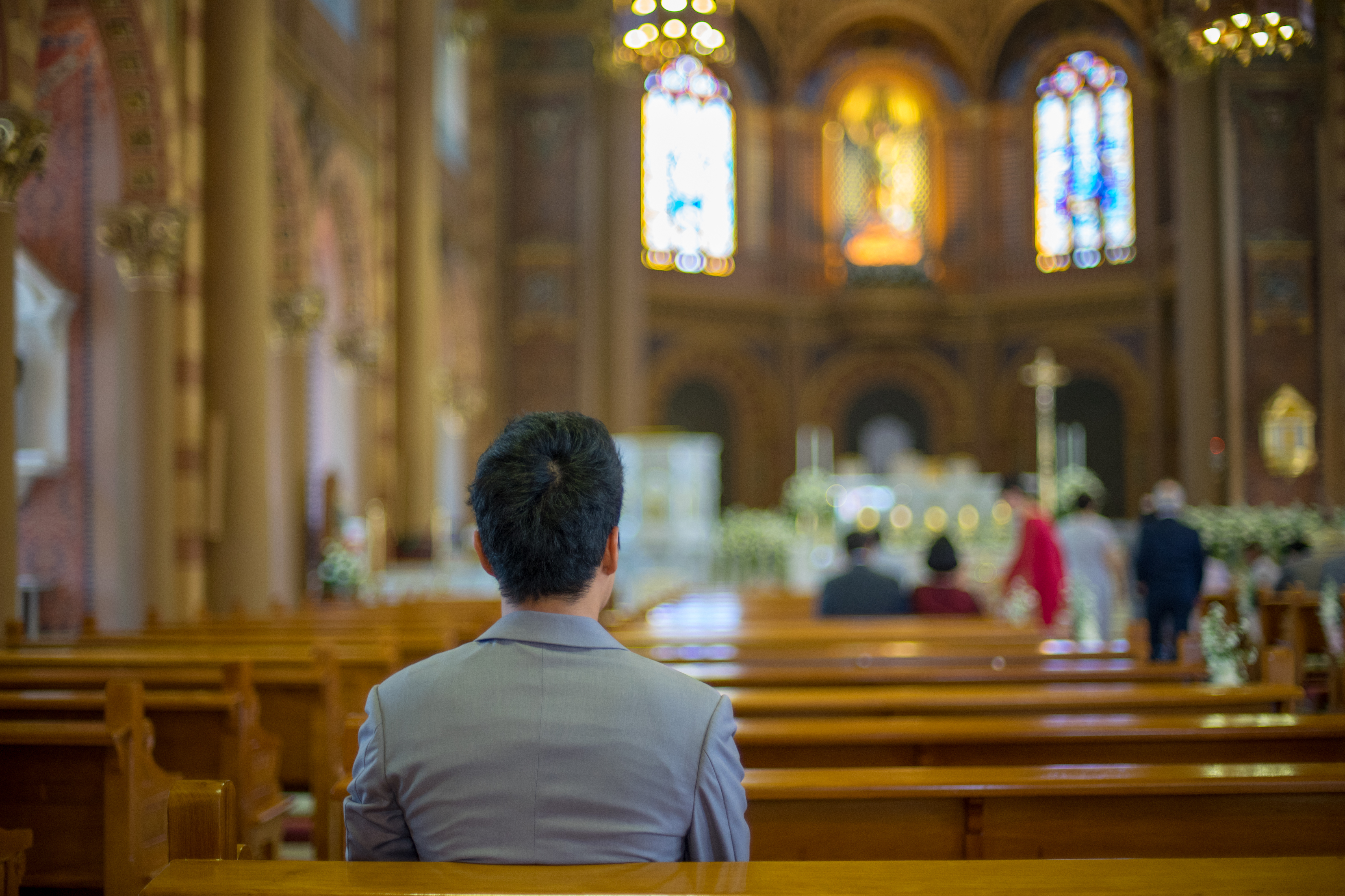 A young man sits at church | Source: Shutterstock