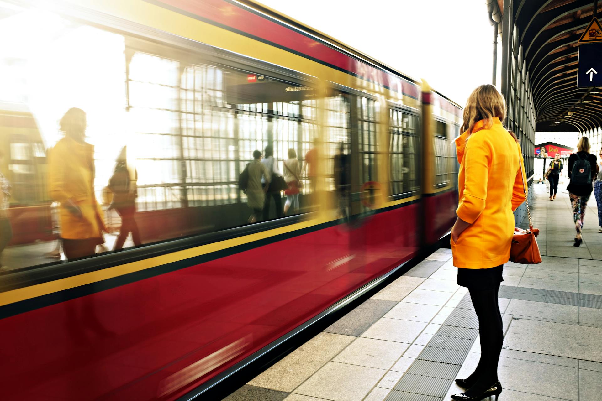 A woman standing beside a red train | Source: Pexels