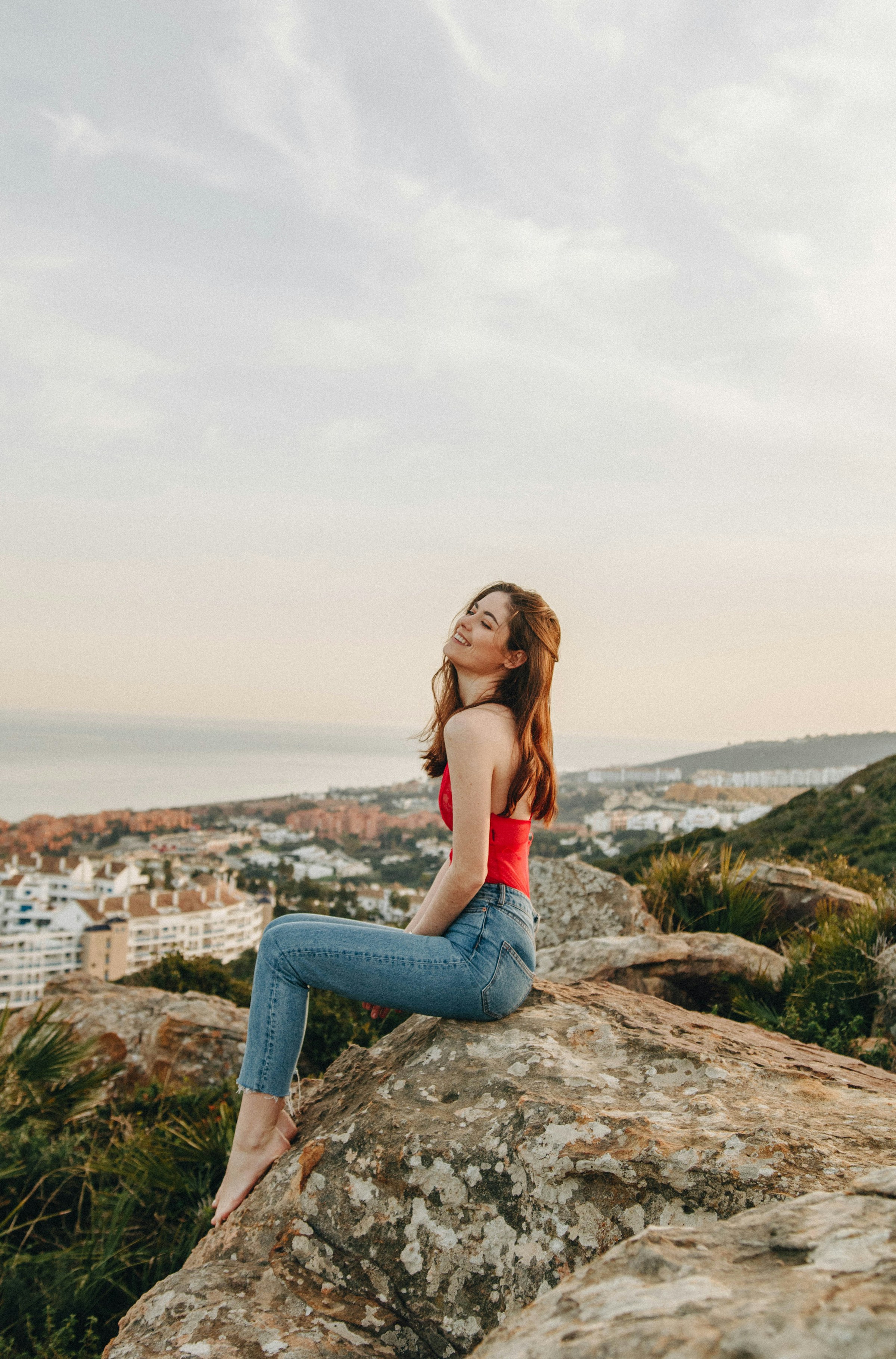 A woman sitting on a rock | Source: Unsplash