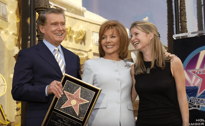 Regis Philbin, his wife Joy and daughter JJ pose for a photograph after receiving a Star on the Hollywood Walk of Fame on April 10, 2003 in Hollywood, California.| Photo: YouTube/ Nicki Swift