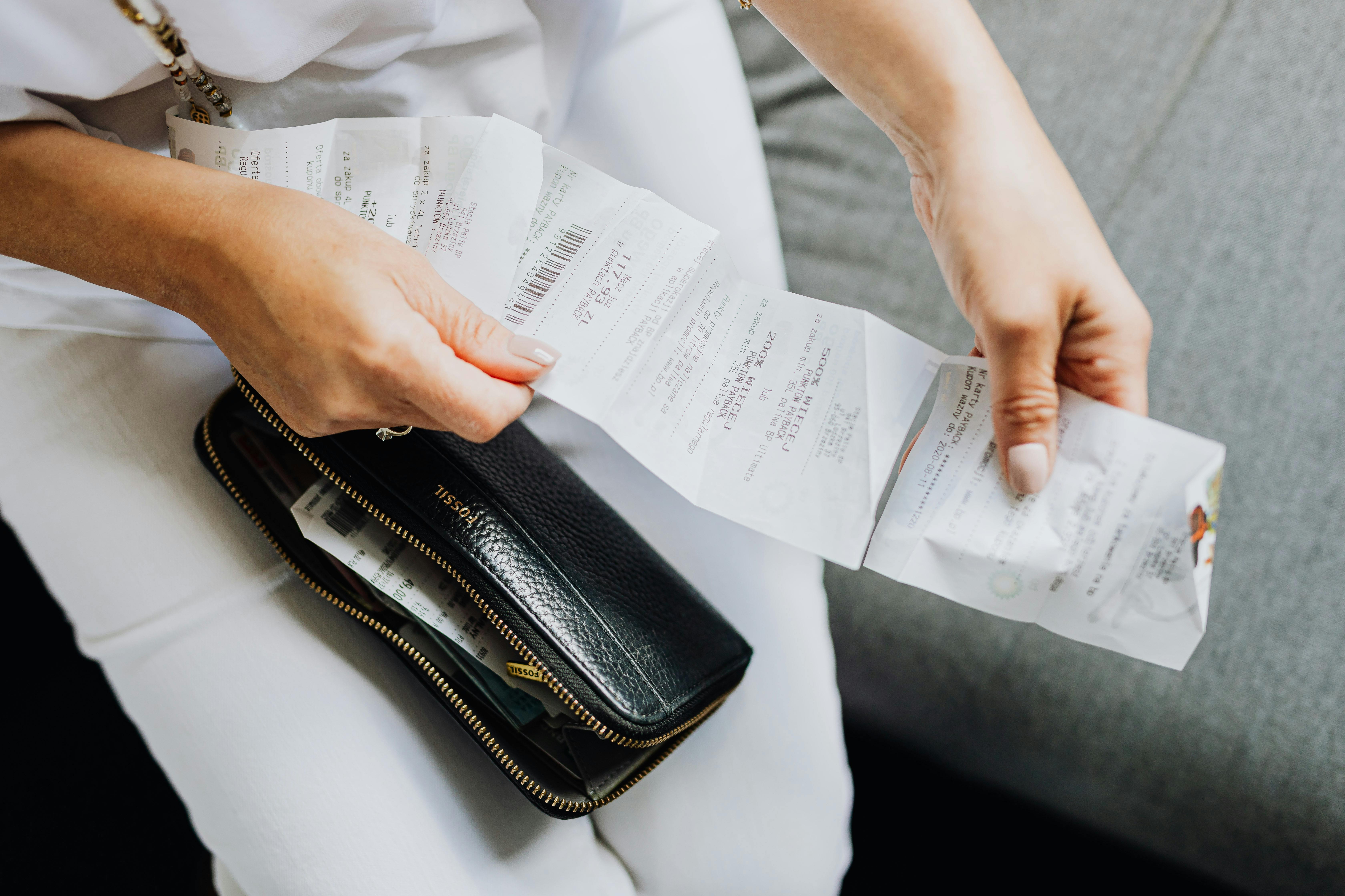 A woman sitting with receipts | Source: Pexels