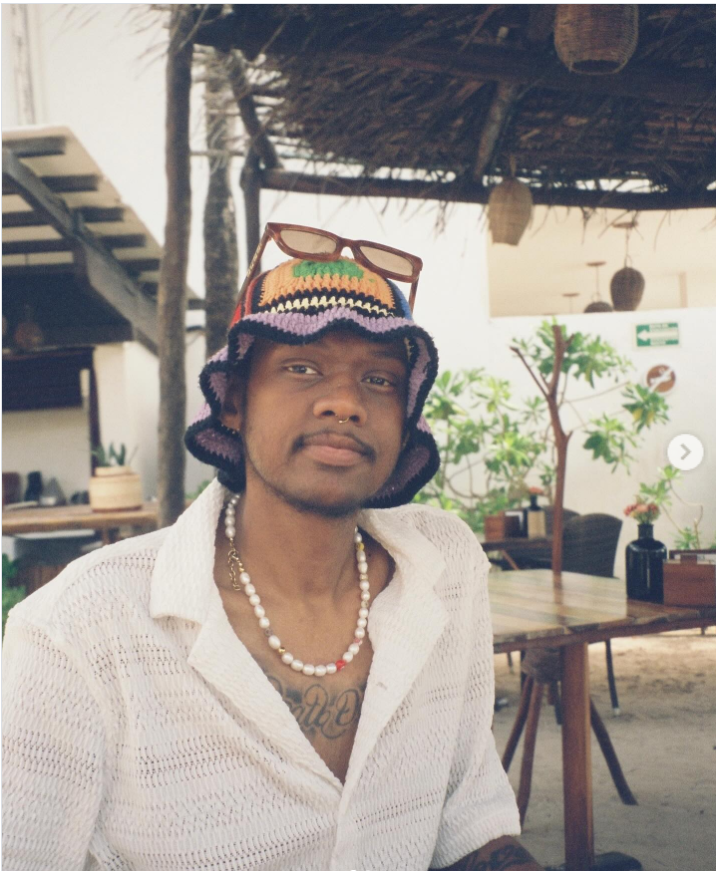 Niko McKnight sits outdoors at a relaxed, open-air setting, from a post dated July 9, 2024. | Source: Instagram/fiftyclicks