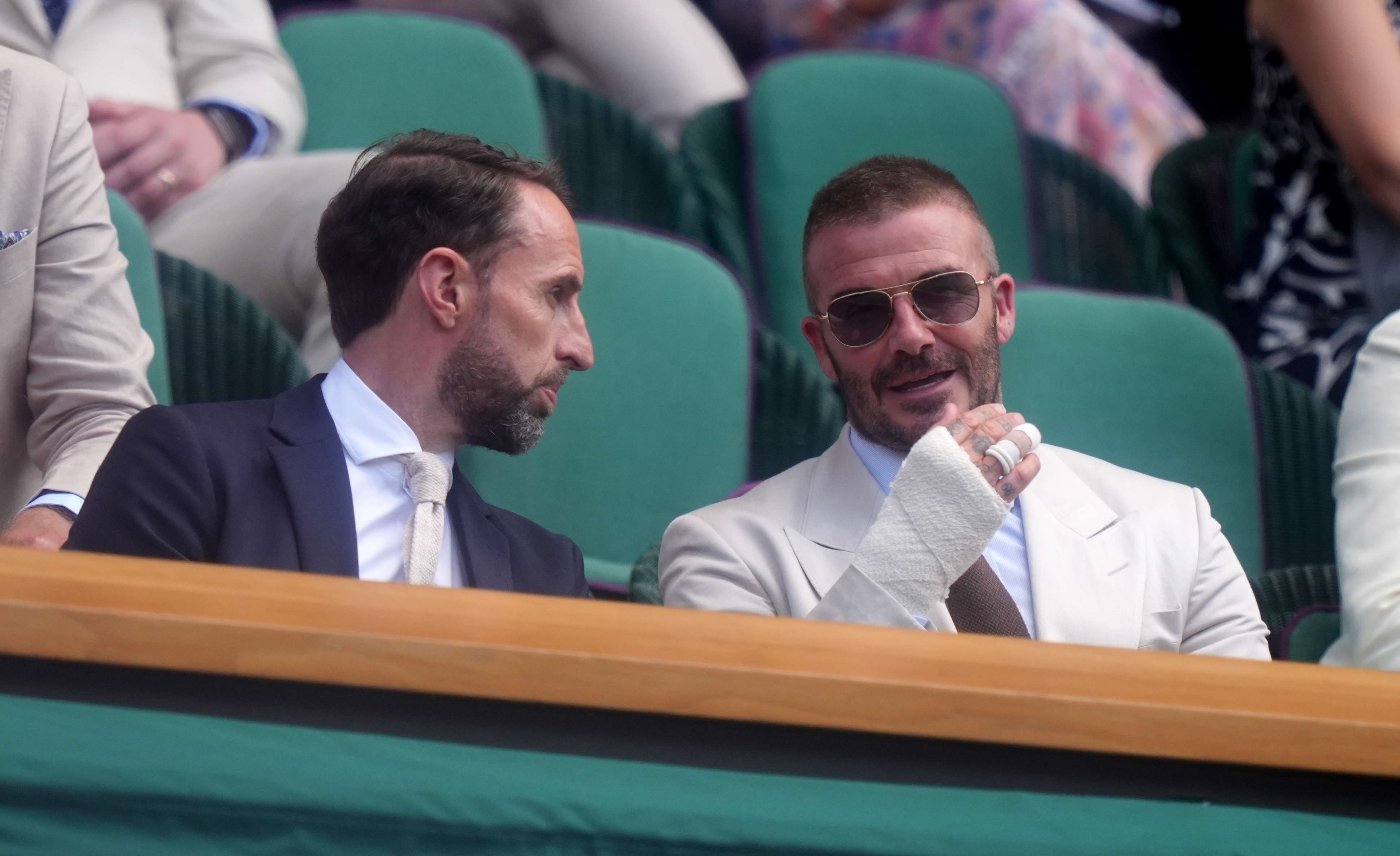 Caught mid-conversation on June 30, 2025, David Beckham leans in as Gareth Southgate animatedly gestures. Beckham, relaxed in his seat, lets his tattoos peek beneath a sharply pressed collar.