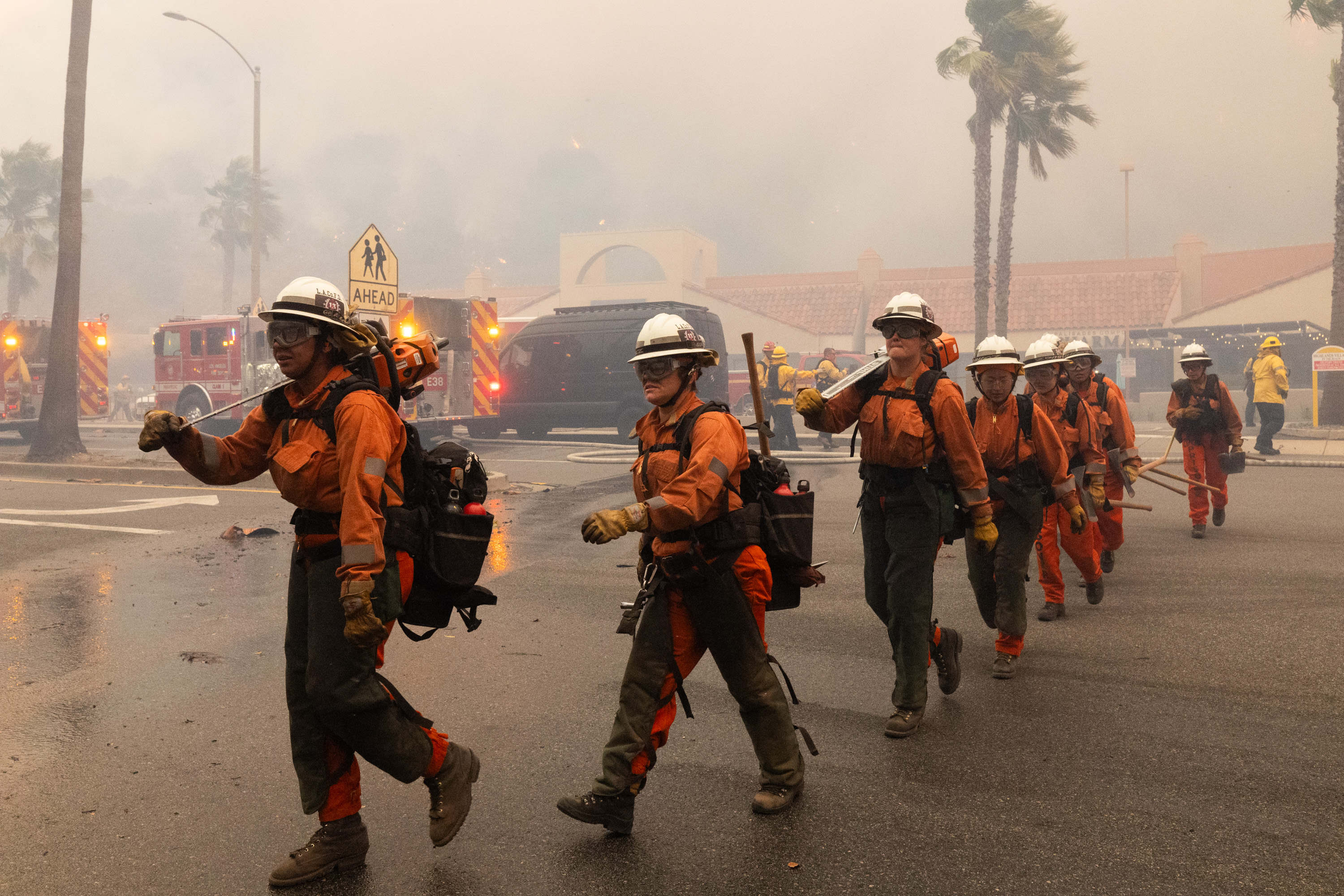 Firefighters work at the site of a brush fire on January 7, 2025 | Source: Getty Images