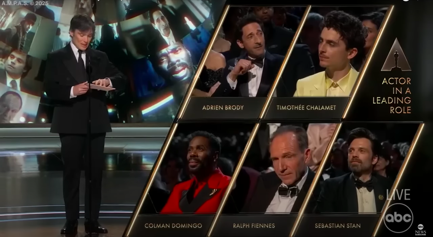 Cillian Murphy about to announce the winner of the Best Actor category as Adrien Brody, Timothée Chalamet, Sebastian Stan, Ralph Fiennes, and Colman Domingo look on. | Source: YouTube/ABC News