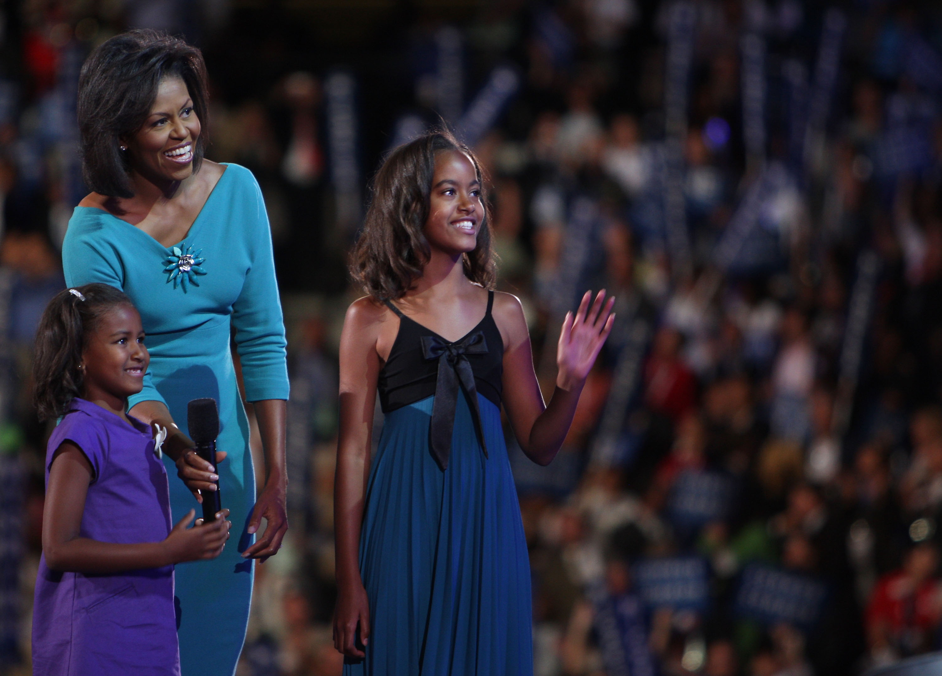 Michelle Obama stands with her daughters Sasha and Malia Obama on stage during day one of the Democratic National Convention (DNC) on August 25, 2008, in Denver, Colorado | Source: Getty Images