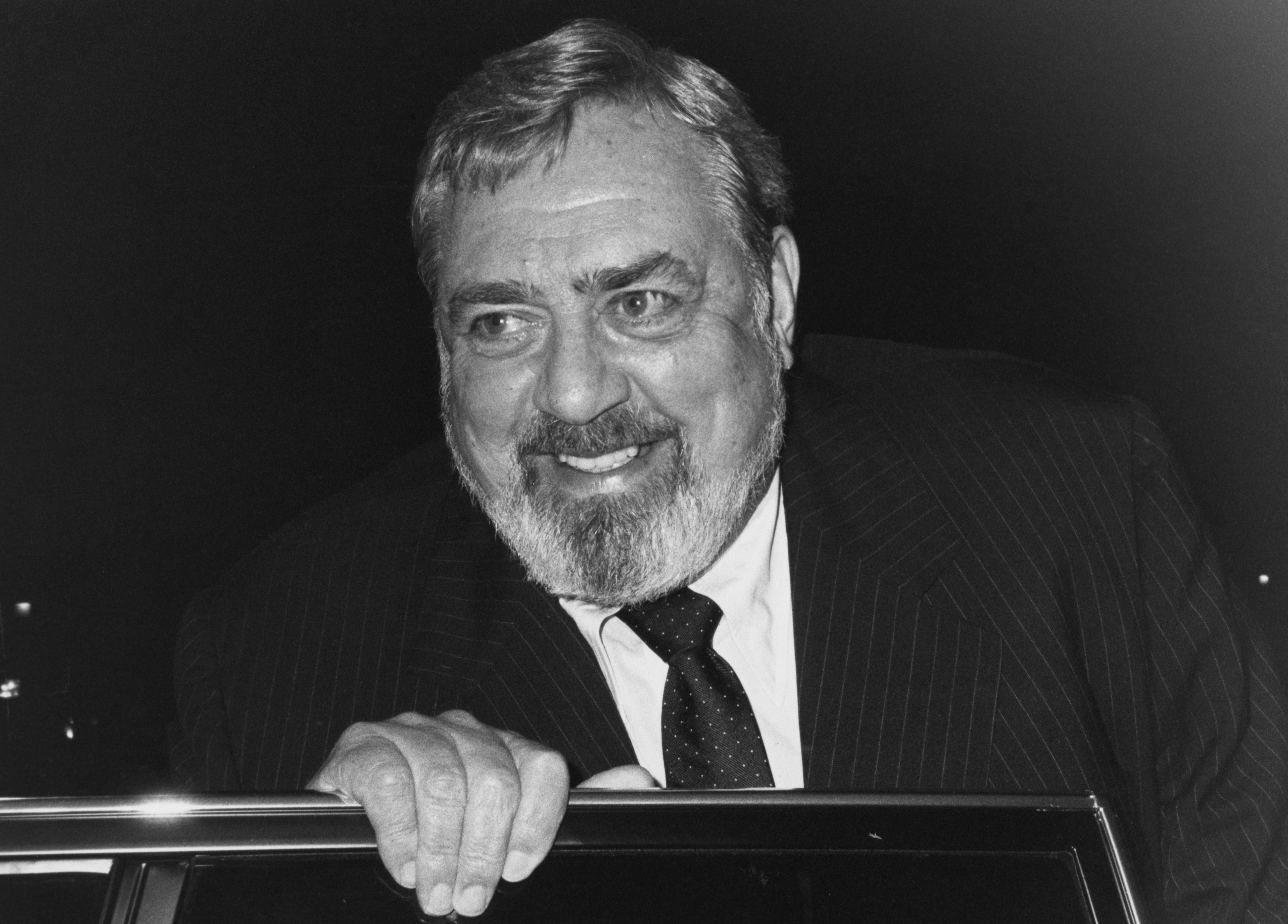 Raymond Burr photographed smiling with his hand on a car door in 1985 Los Angeles, California. / Source: Getty Images