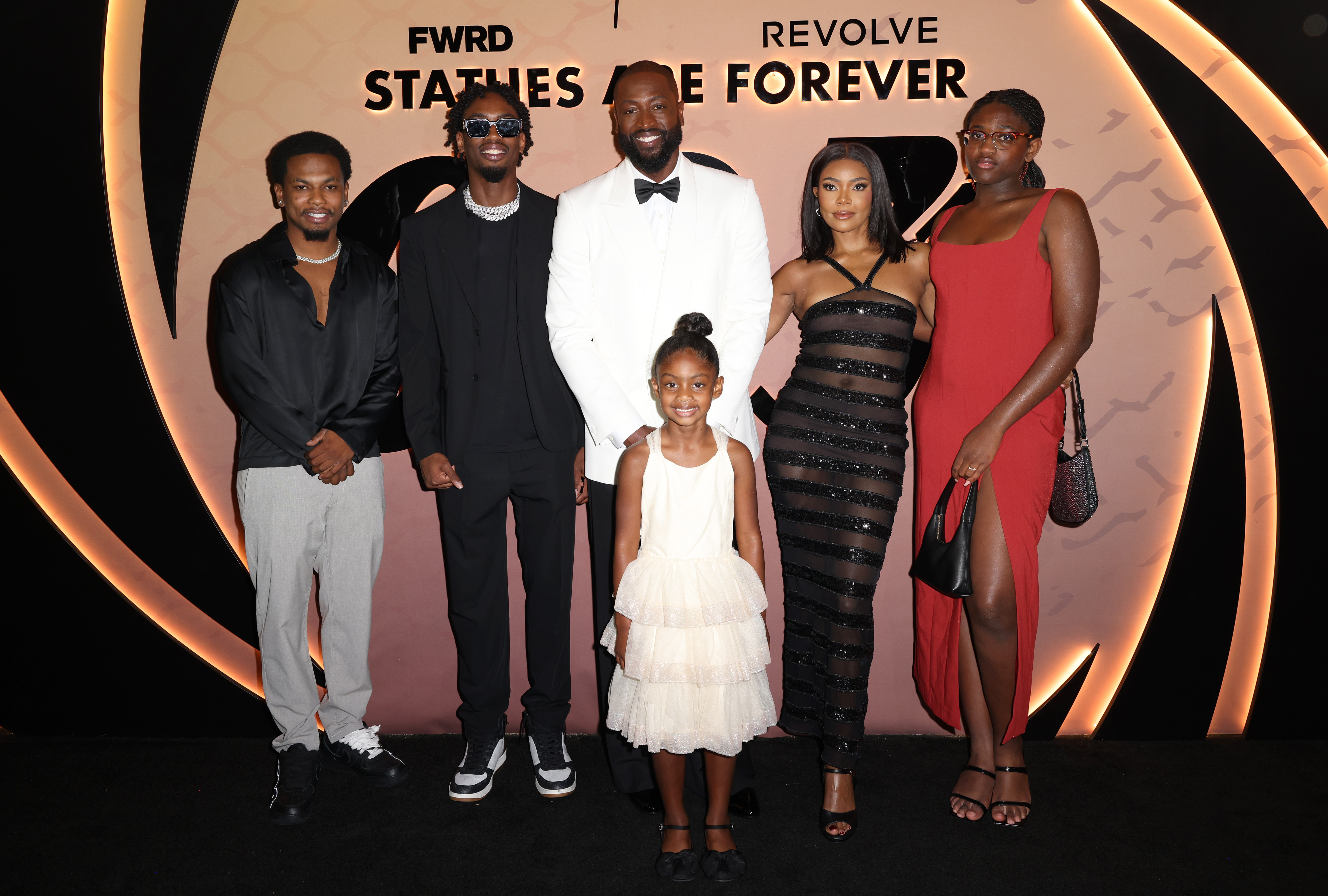 Dwyane Wade and Gabrielle Union with their children, Dahveon Morris, Zaire, Kaavia, and Zaya at Queen Miami Beach in Florida on October 25, 2024 | Source: Getty Images